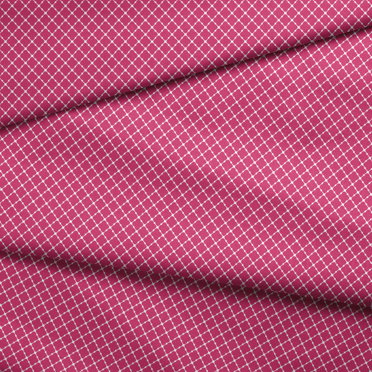 Pink quatrefoil pattern with white outlines forming a Moroccan-style geometric design fabric fold mockup