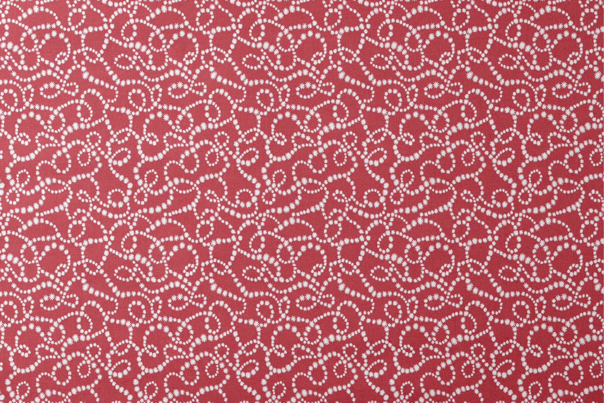 White dotted swirl pattern on rich red background creating decorative curving lines designs flat mockup