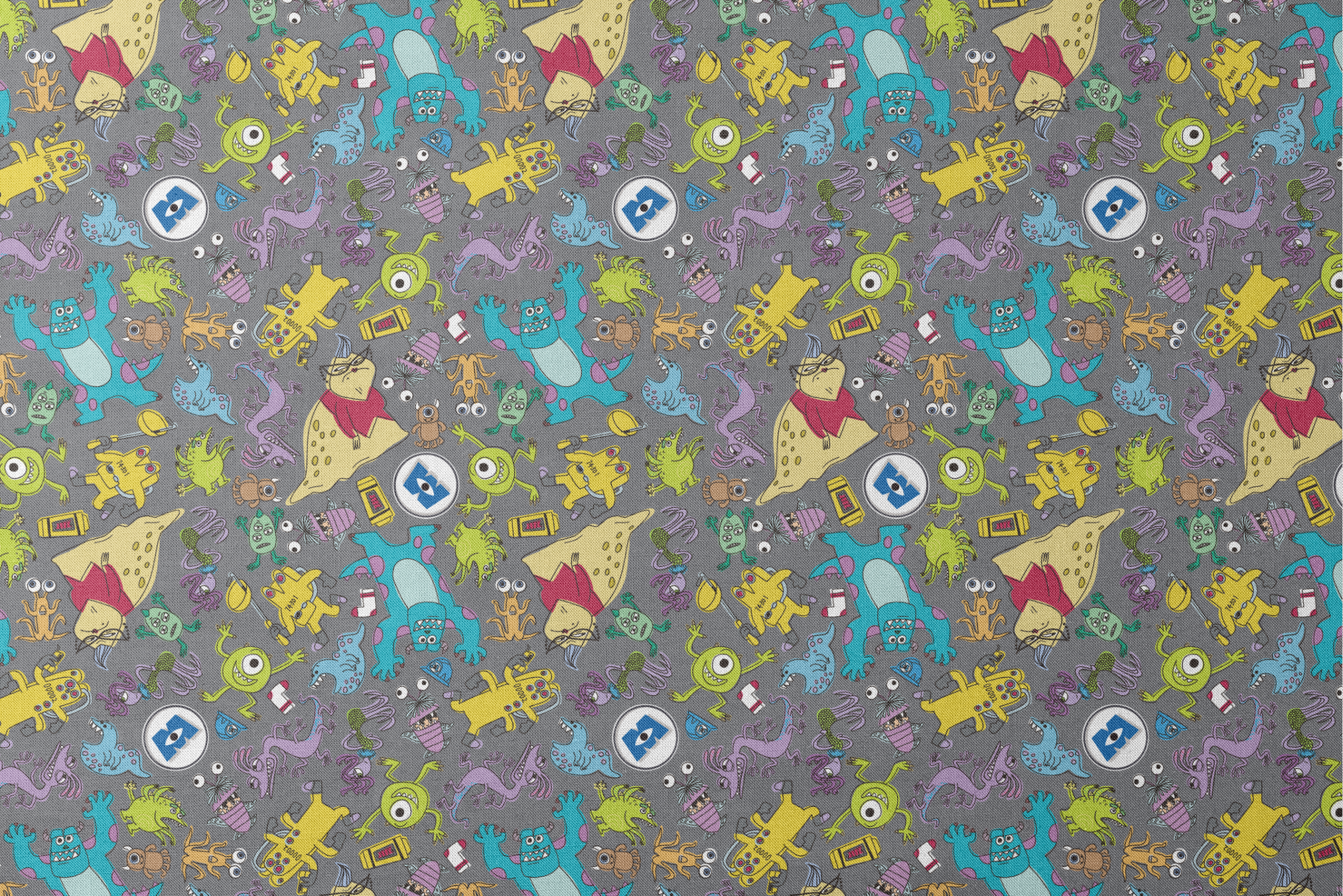 Colorful Monsters Inc pattern with various whimsical creatures in yellow, blue, green, and purple on a gray background. designs flat mockup