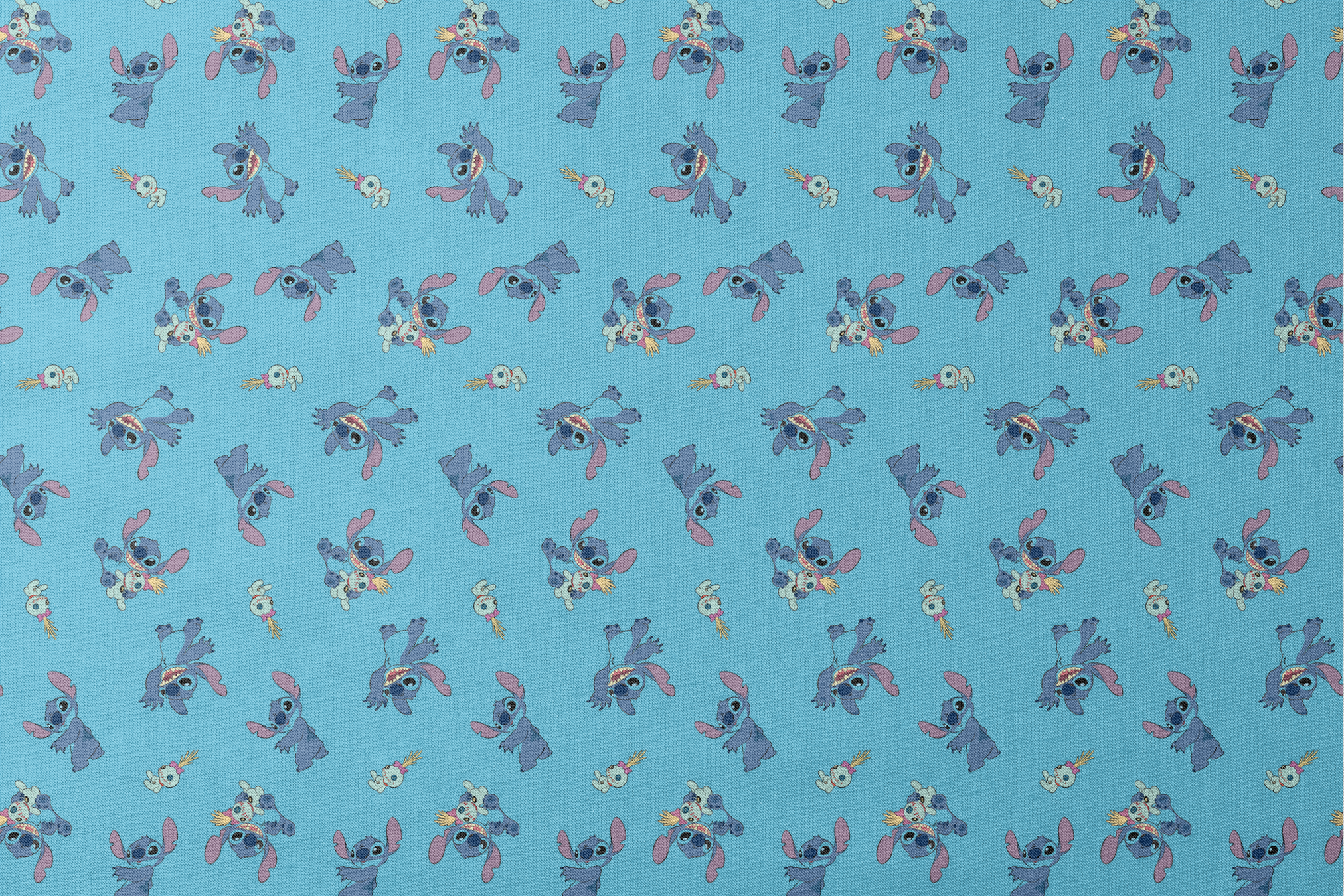 Disney’s Stitch and Scrump in various playful poses scattered across a light blue background with small tropical flowers. designs flat mockup