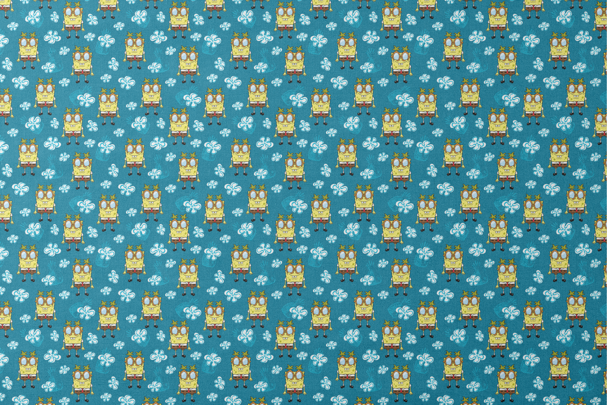 Yellow cartoon character with glasses on teal background with white flower pattern, repeating design designs flat mockup