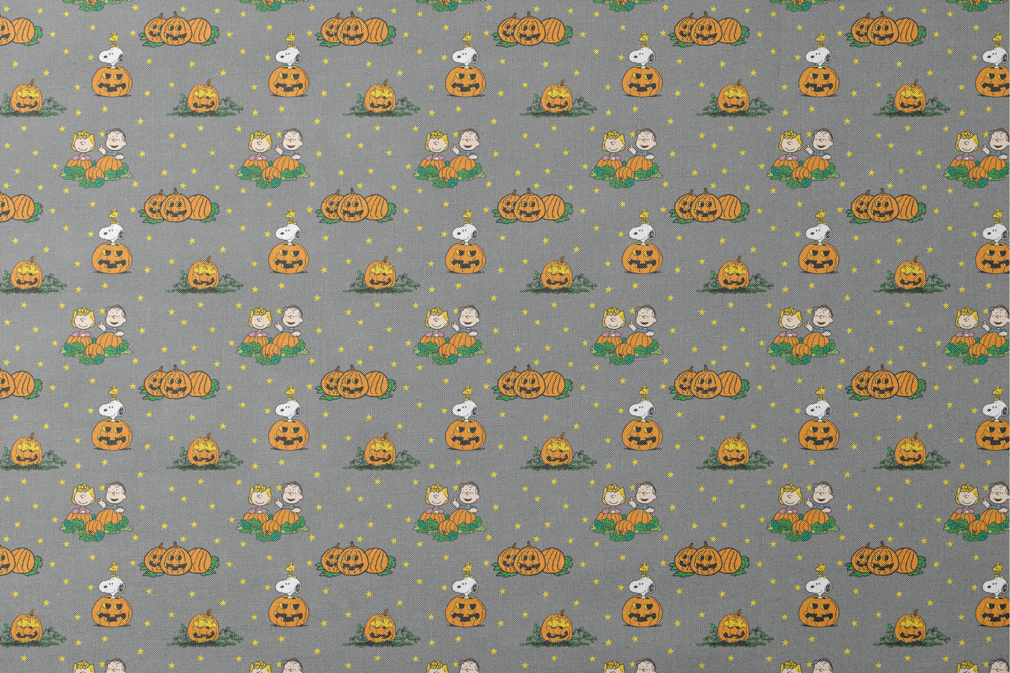 Peanuts Halloween pattern with Snoopy on pumpkins, Peanuts characters in pumpkin patches, and yellow stars on gray background. designs flat mockup