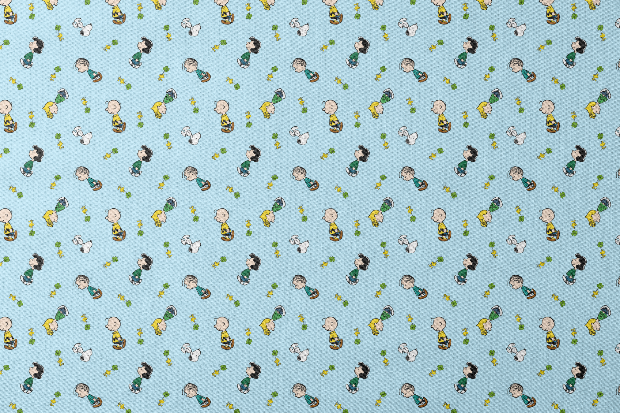Peanuts cartoon characters on light blue background with clovers designs flat mockup
