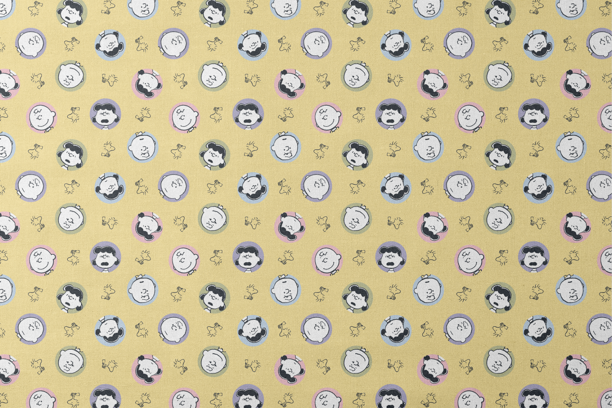 Peanuts characters pattern with Charlie Brown and friends in circular frames on yellow background with Woodstock silhouettes designs flat mockup