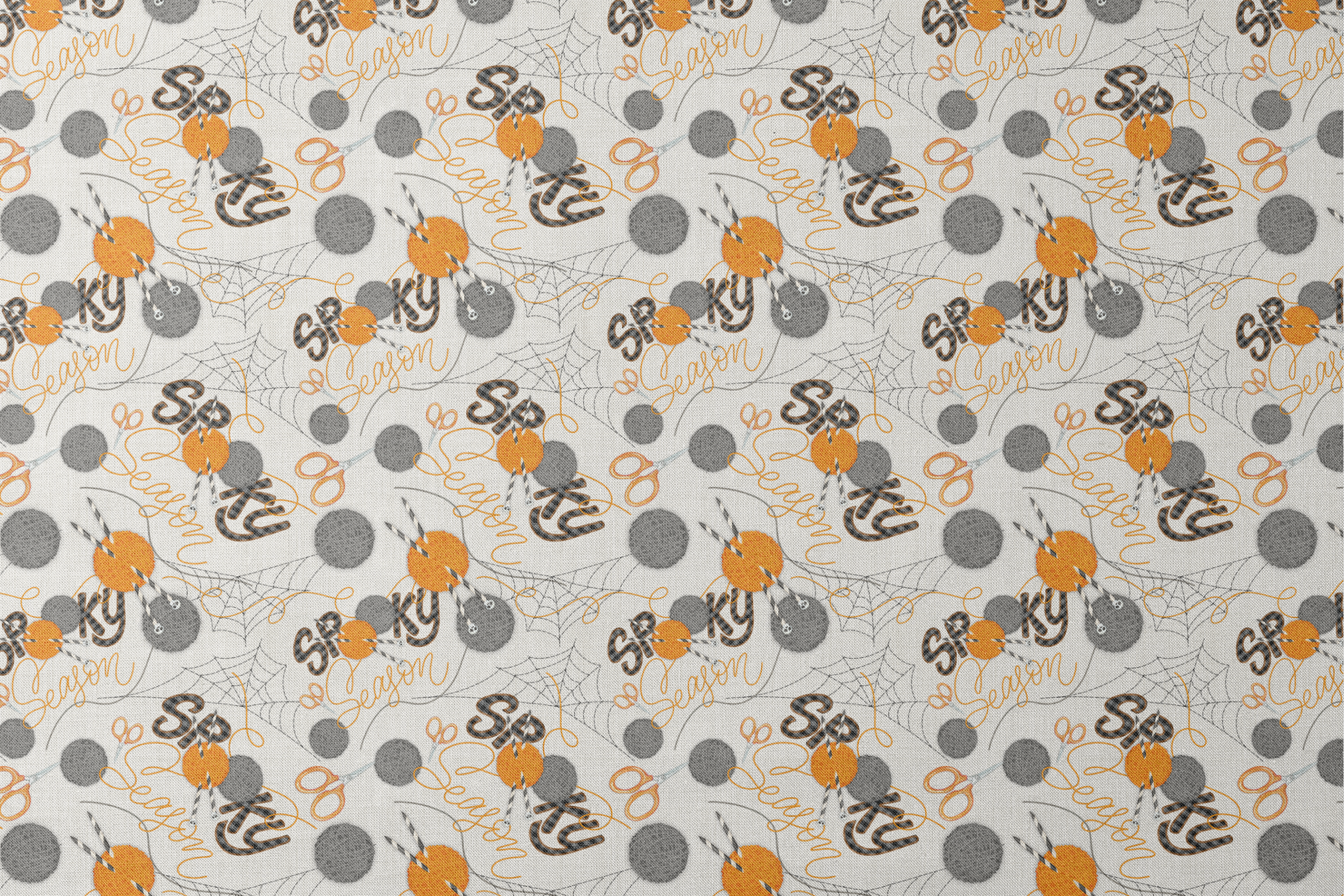 Halloween design by Nicole Tamarin featuring orange and gray yarn balls, scissors, spiderwebs, and “Spooky Season” lettering on a cream background. designs flat mockup