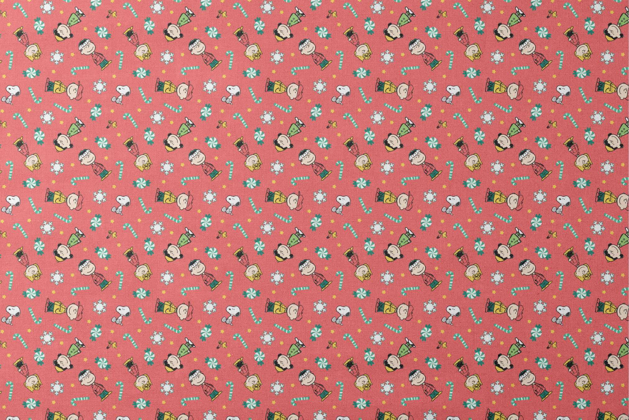 Festive Peanuts cartoon pattern with Charlie Brown characters, candy canes, snowflakes, and peppermints on red background designs flat mockup