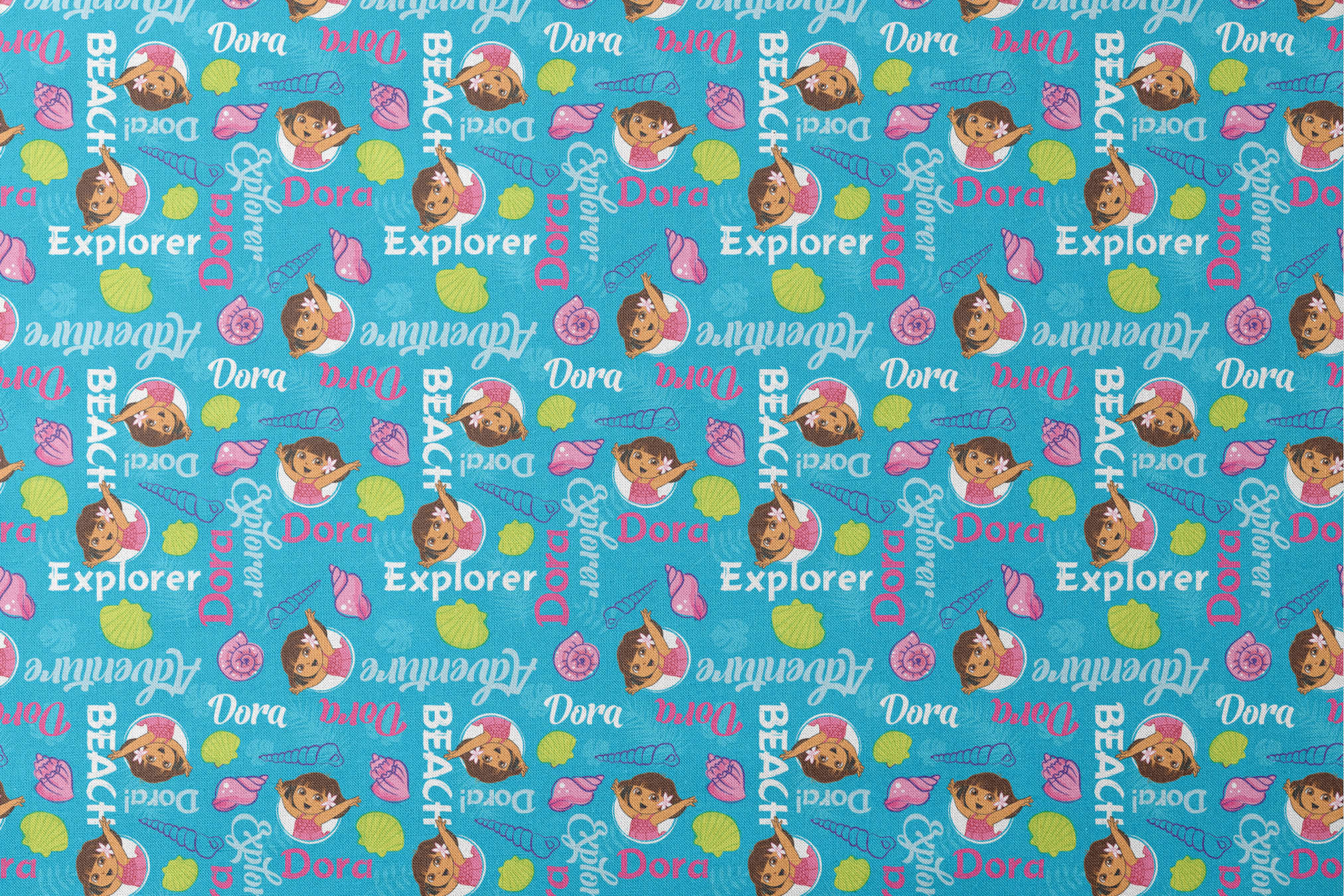 Bright blue pattern featuring Dora the Explorer cartoon character with seashells and "Beach Explorer" text designs flat mockup