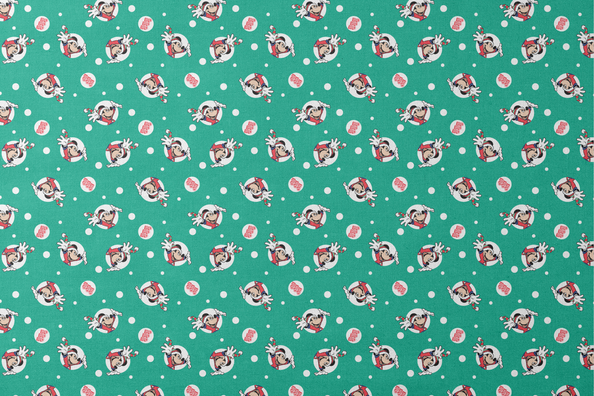 Mickey Mouse in Santa hats on green polka dot background with "Ho Ho Ho" text designs flat mockup