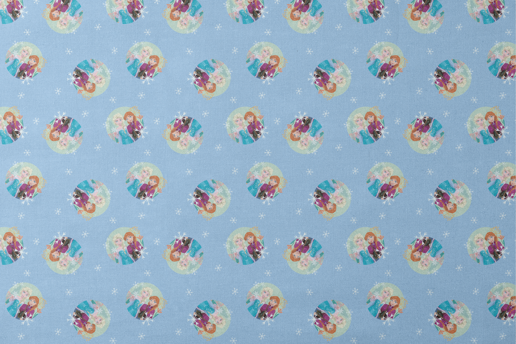 Light blue background with repeating circular motifs of "Frozen" characters and snowflakes in a decorative pattern designs flat mockup