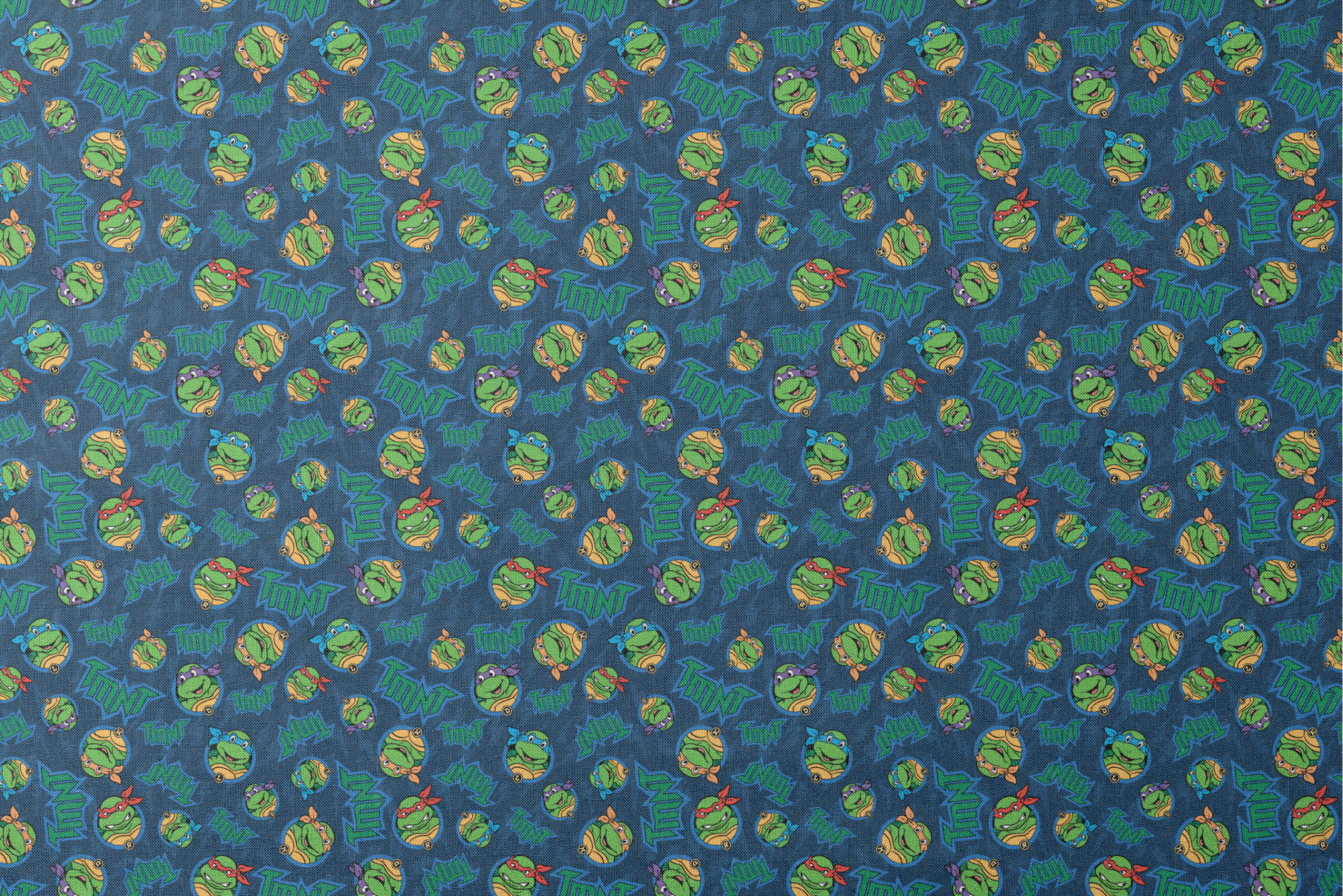 Teenage Mutant Ninja Turtles pattern with character heads and TMNT logos on blue background designs flat mockup