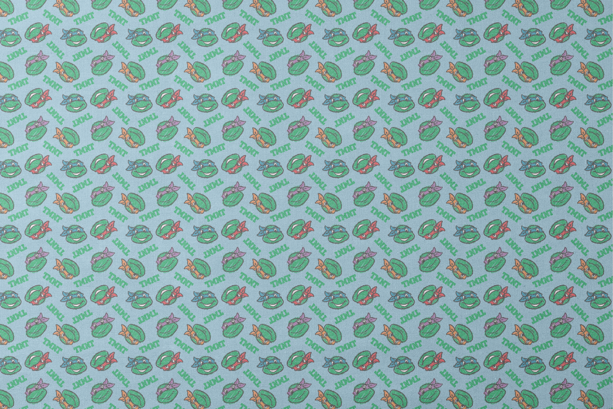 Cartoon pattern of Teenage Mutant Ninja Turtles faces with colored masks on light blue background designs flat mockup
