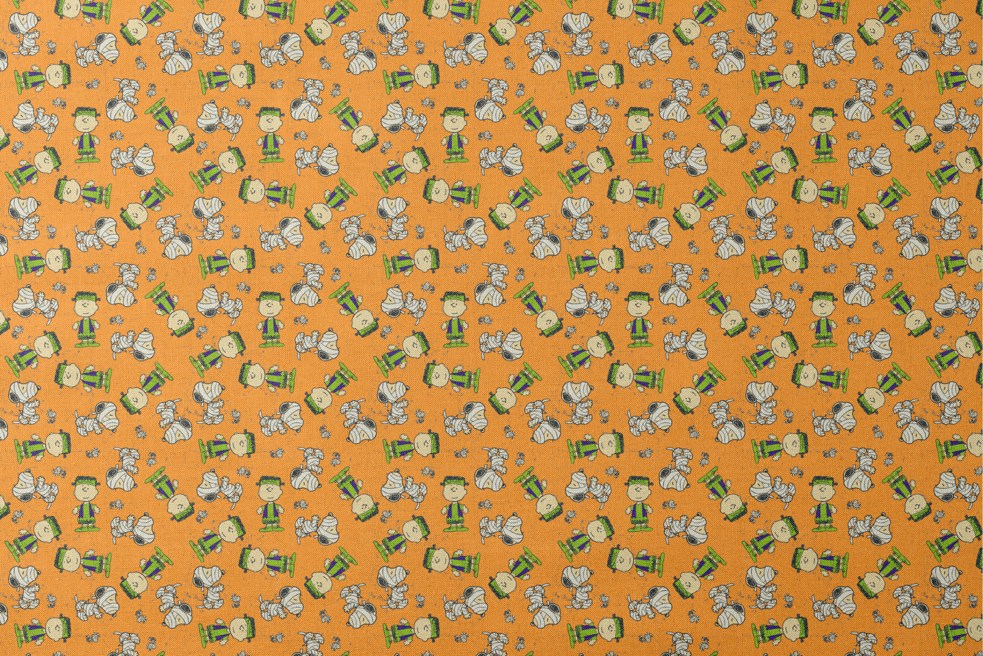Peanuts characters pattern on orange background with Charlie Brown, Snoopy, and friends scattered throughout designs flat mockup