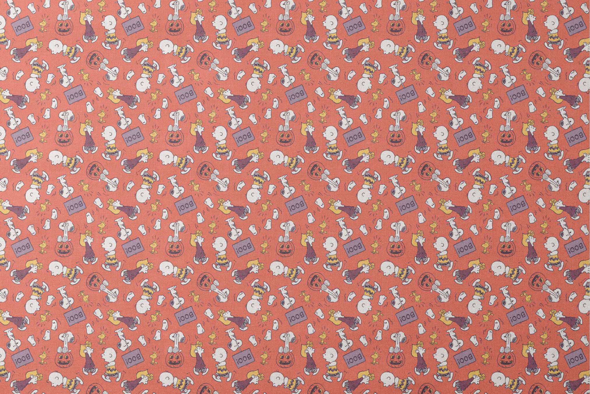 Snoopy and Woodstock Halloween pattern on orange background with pumpkins, ghosts, and "boo" text designs flat mockup