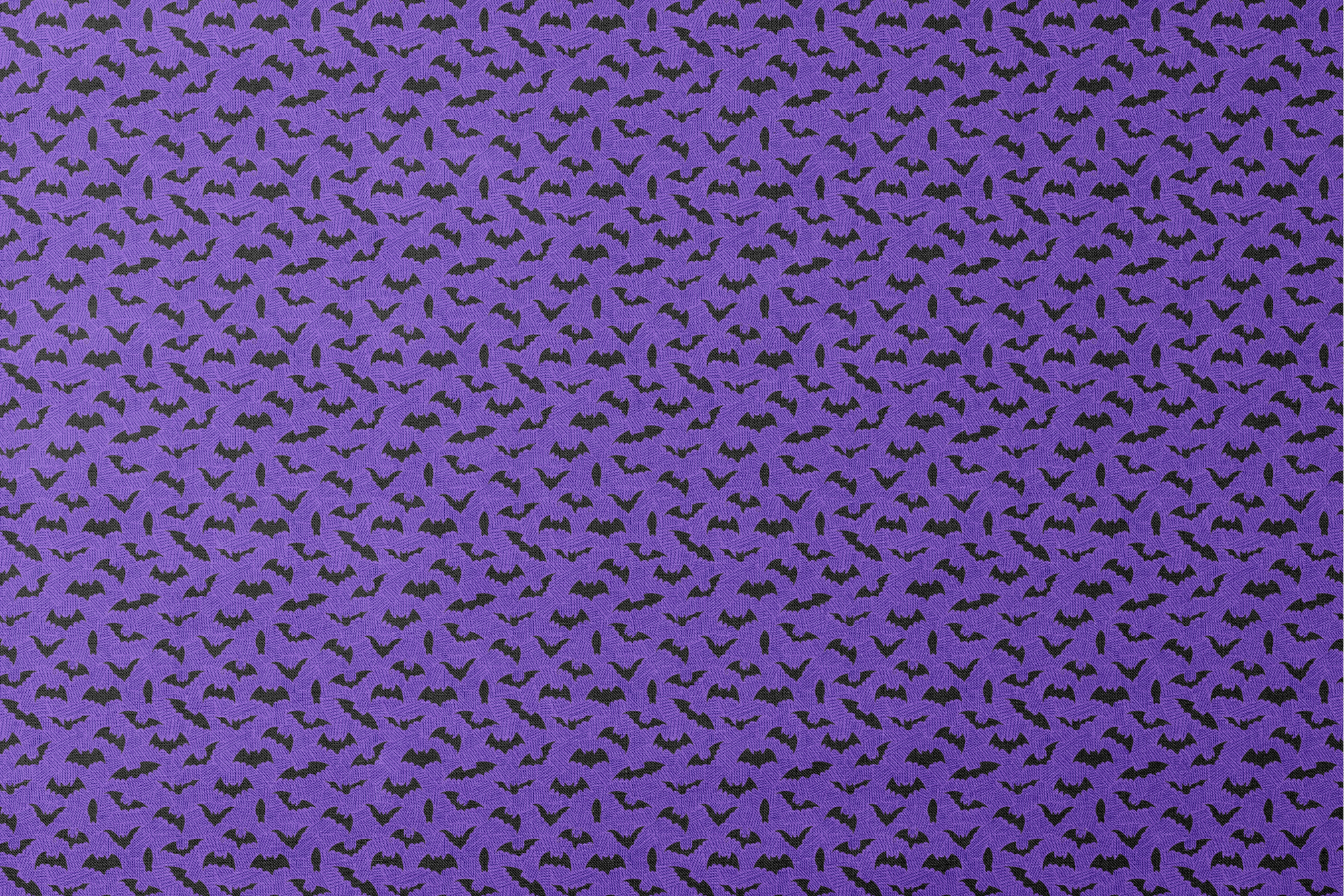 Black bat silhouettes scattered over purple zigzag background, Halloween-themed pattern designs flat mockup