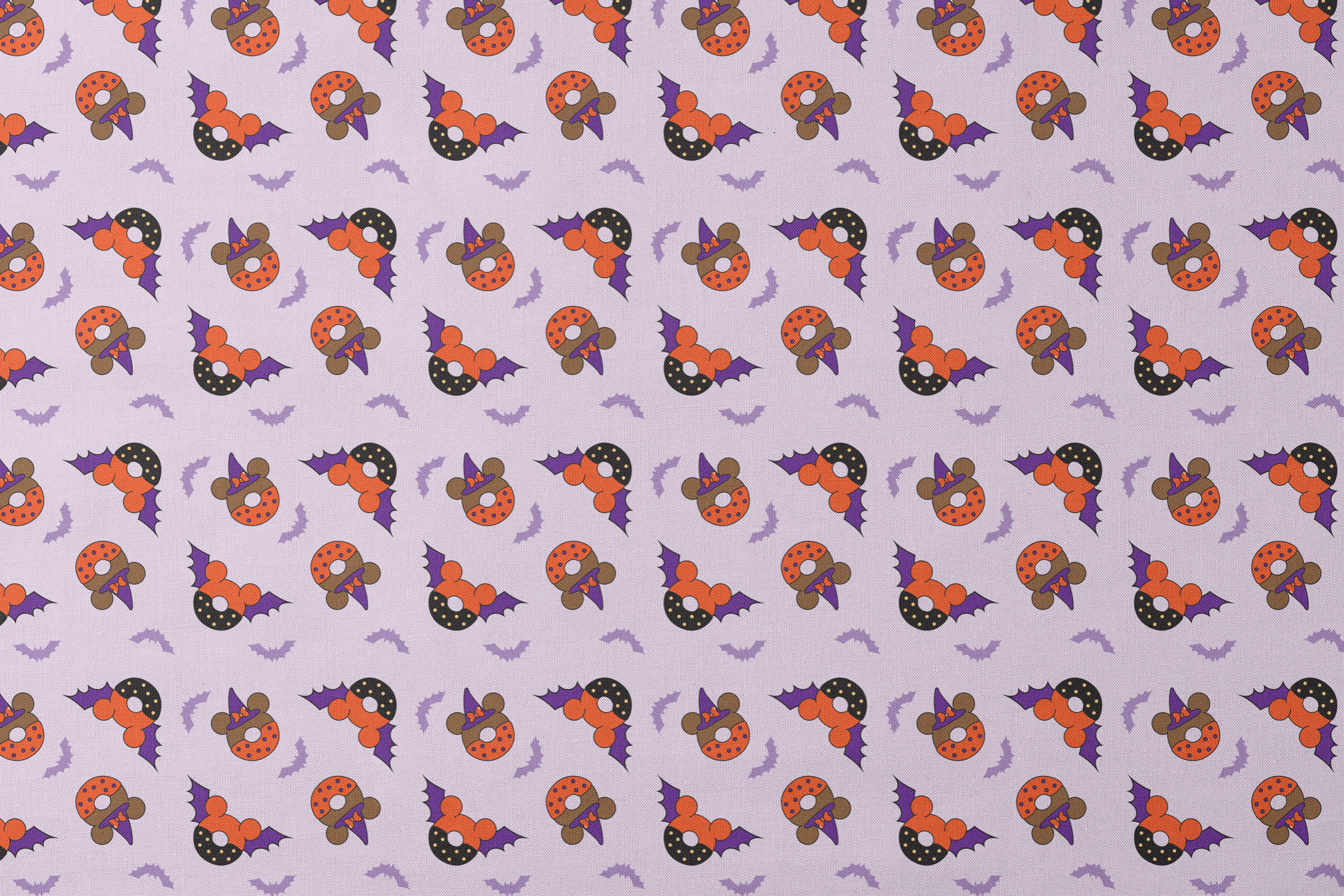 Disney Halloween-themed pattern with orange and black donuts, purple bat wings, and light purple bats on lavender background designs flat mockup