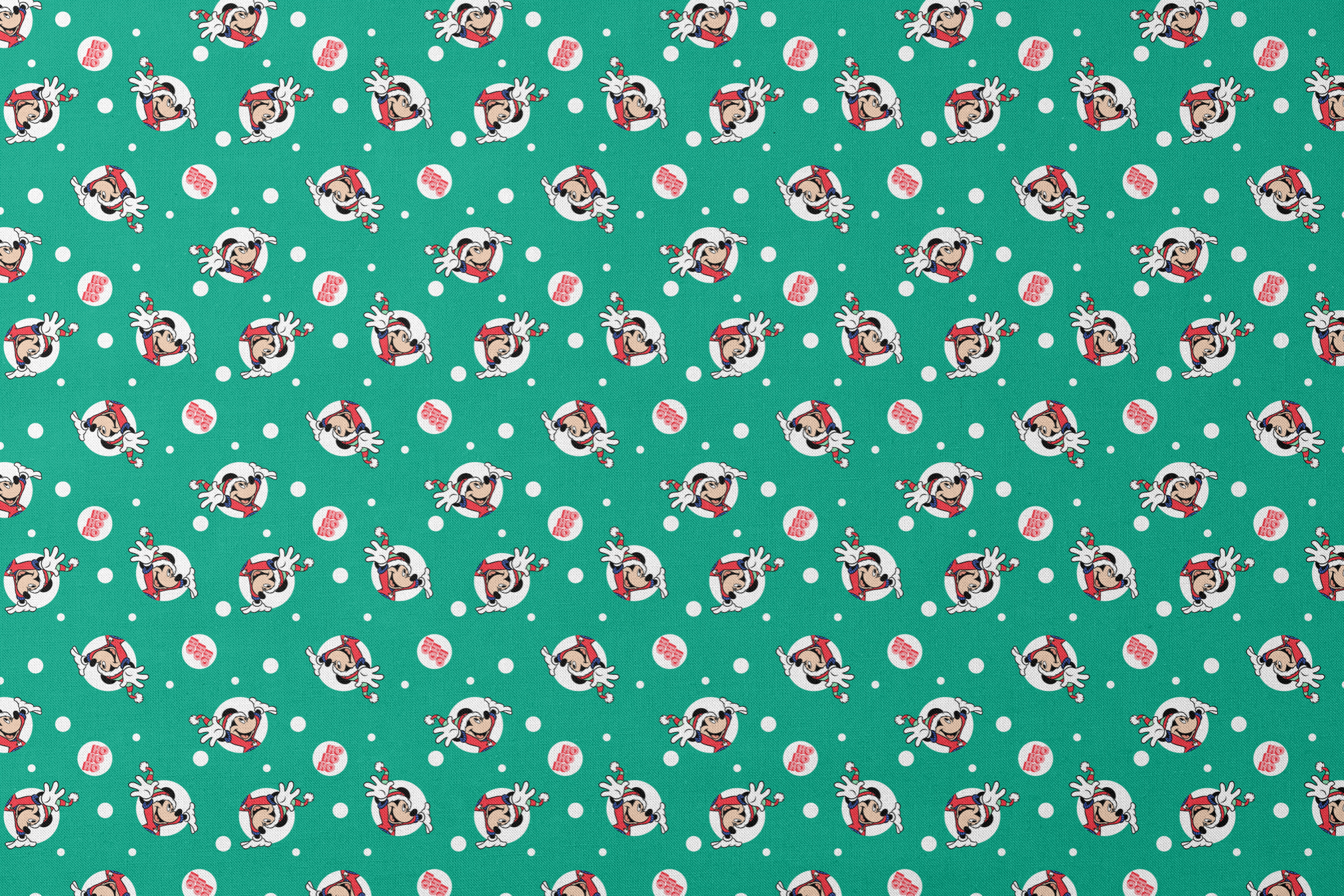 Mickey Mouse in Santa hats on green polka dot background with "Ho Ho Ho" text designs flat mockup