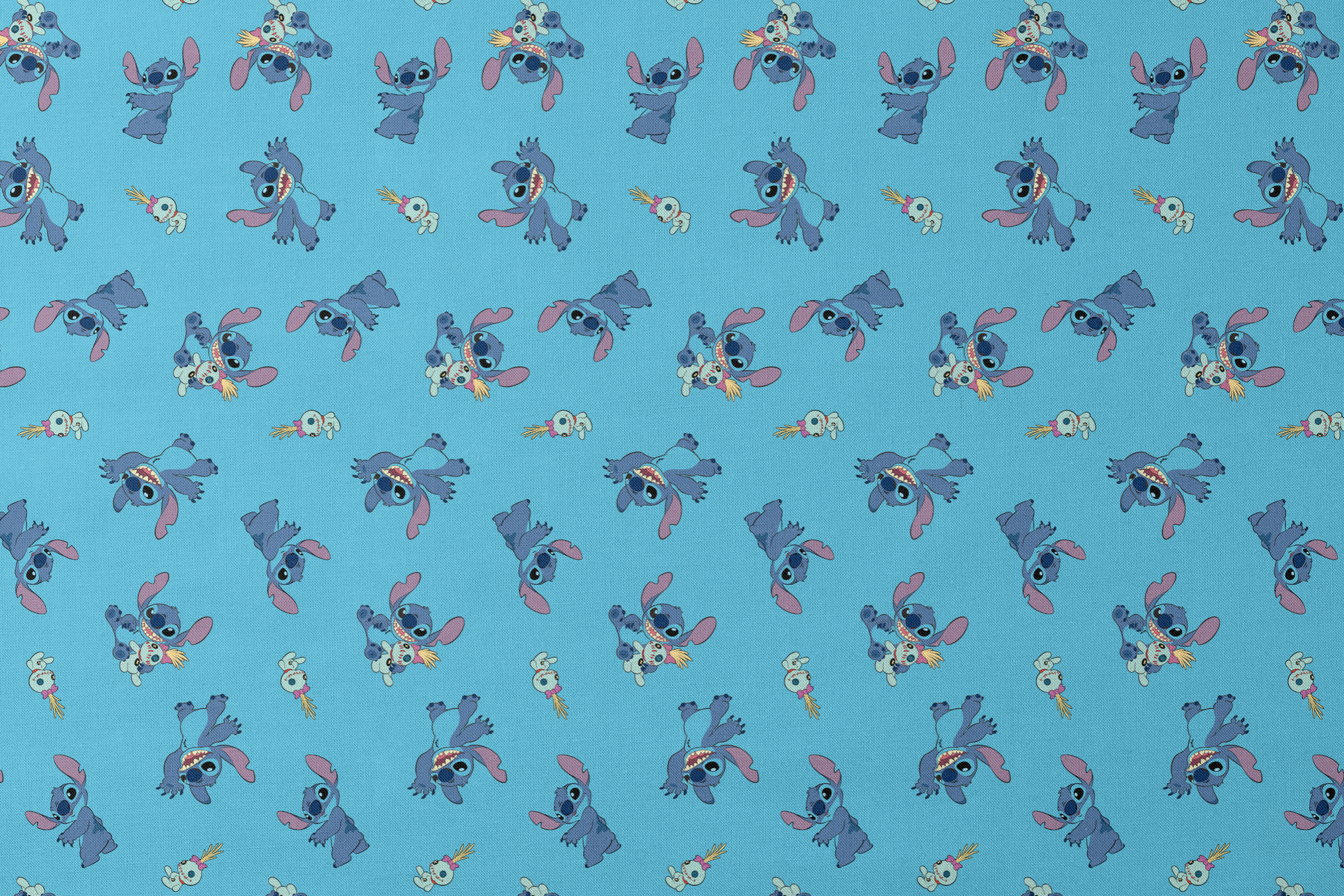Disney’s Stitch and Scrump in various playful poses scattered across a light blue background with small tropical flowers. designs flat mockup