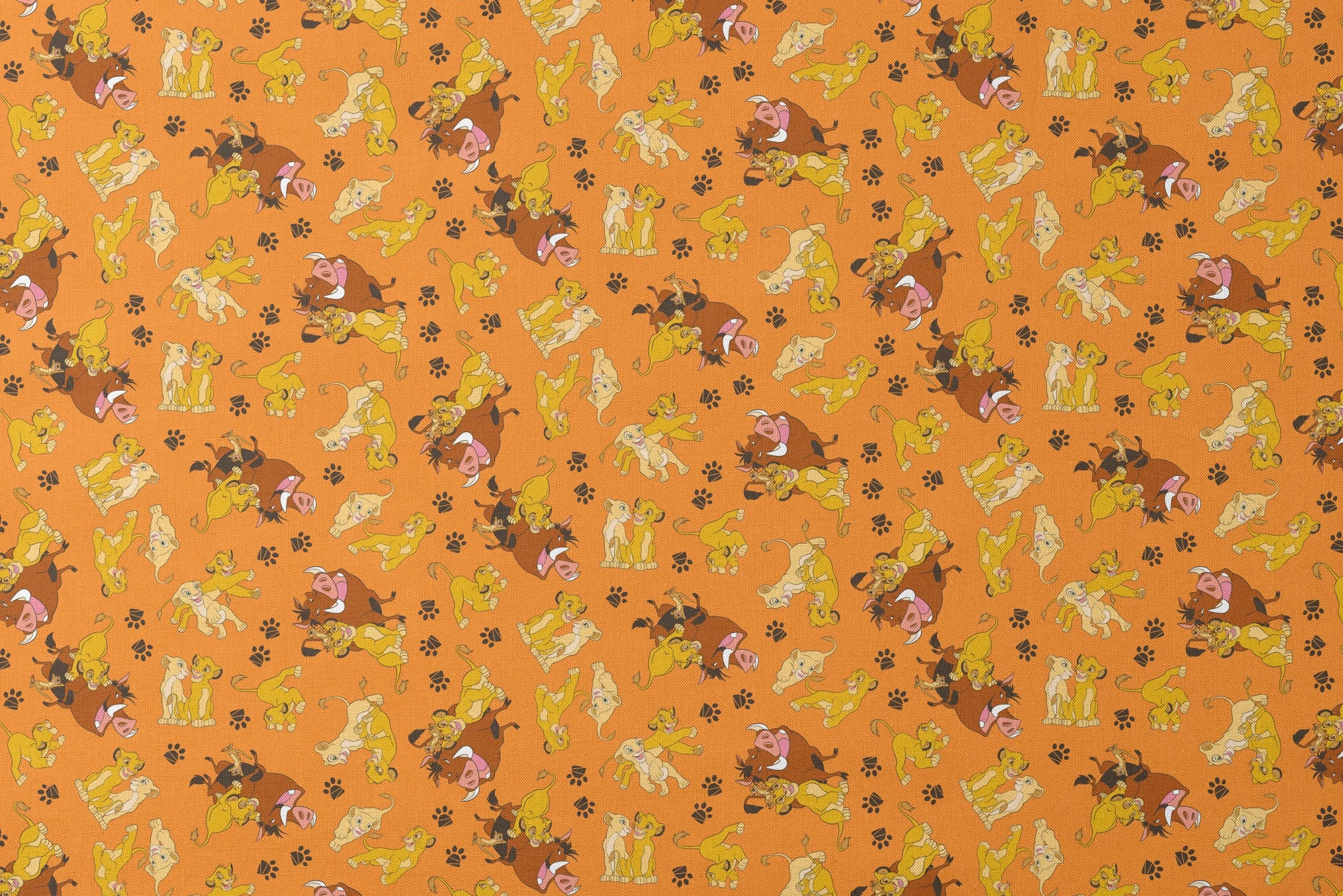 Playful pattern of cartoon cubs in yellow and brown poses on bright orange background with pawprints designs flat mockup