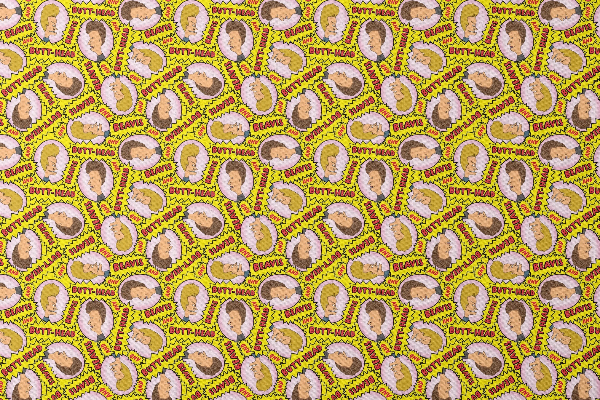Yellow pattern with cartoon characters and text "BEAVIS" and "BUTT-HEAD" in comic-style speech bubbles repeated throughout designs flat mockup