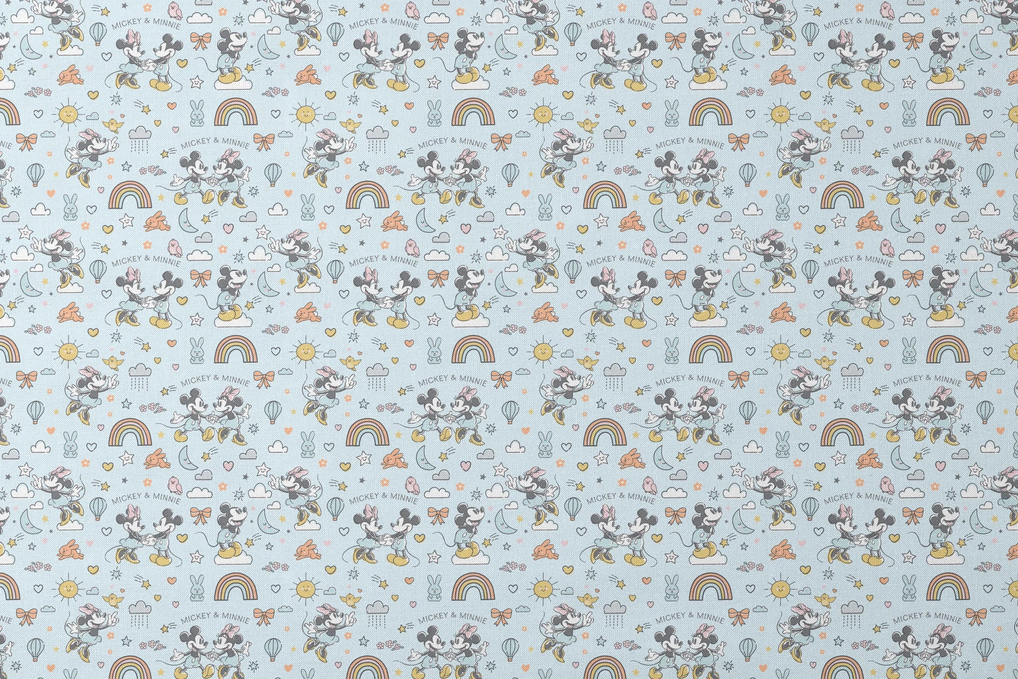 Playful Disney pattern with classic cartoon characters, rainbows, hearts, and whimsical elements on light blue background. designs flat mockup