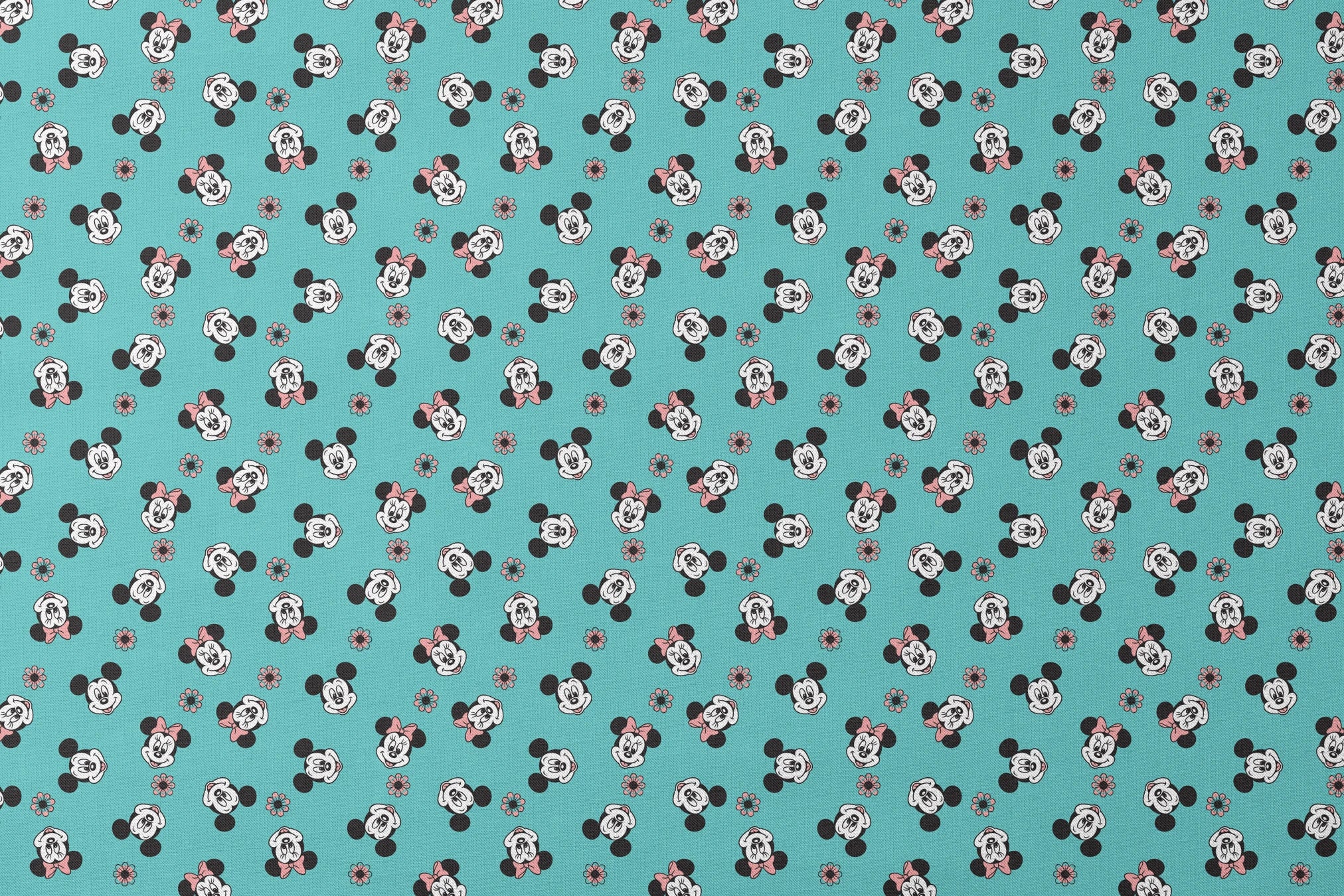 Mickey and Minnie Mouse cartoon faces scattered on turquoise background with small flowers designs flat mockup
