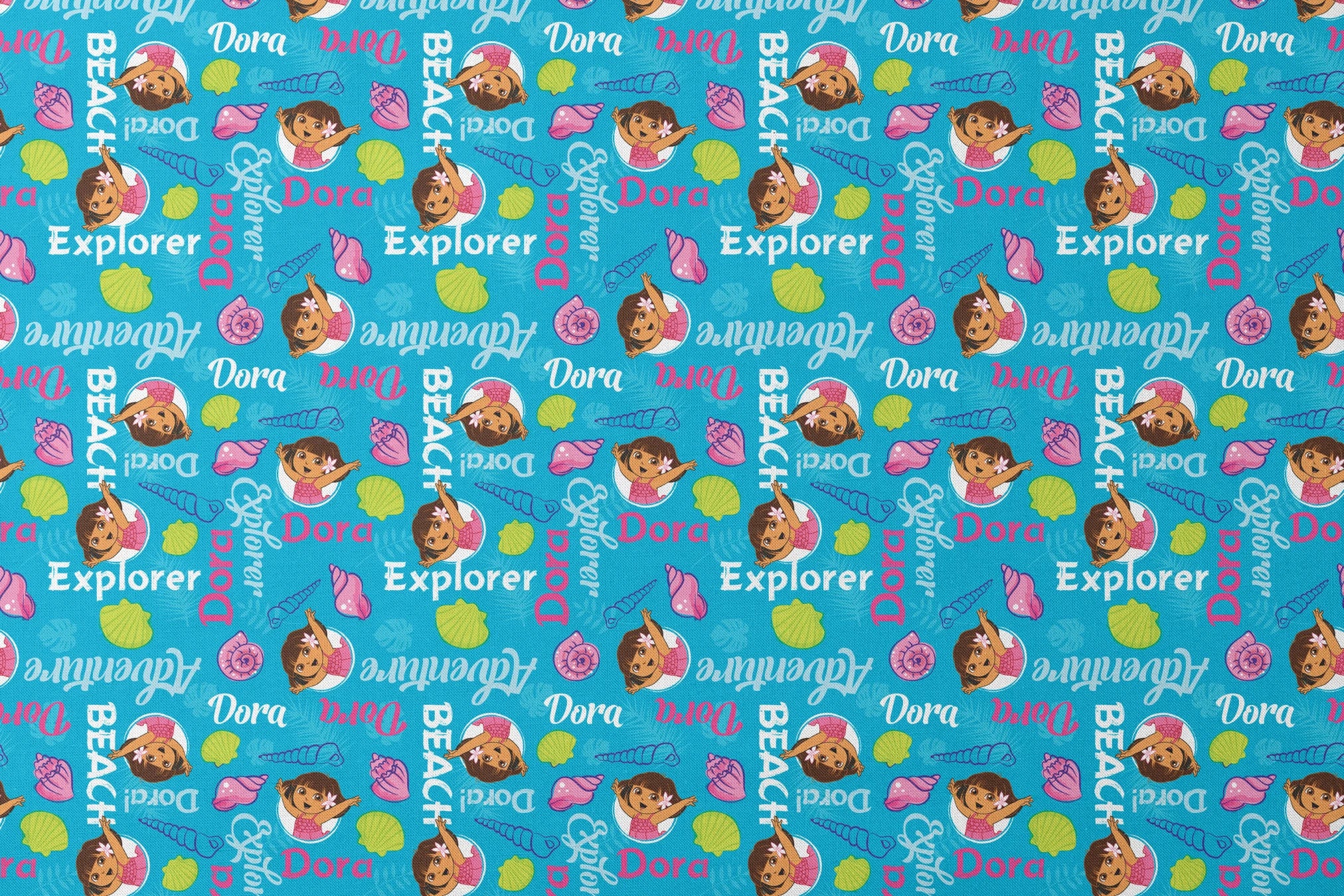 Bright blue pattern featuring Dora the Explorer cartoon character with seashells and "Beach Explorer" text designs flat mockup