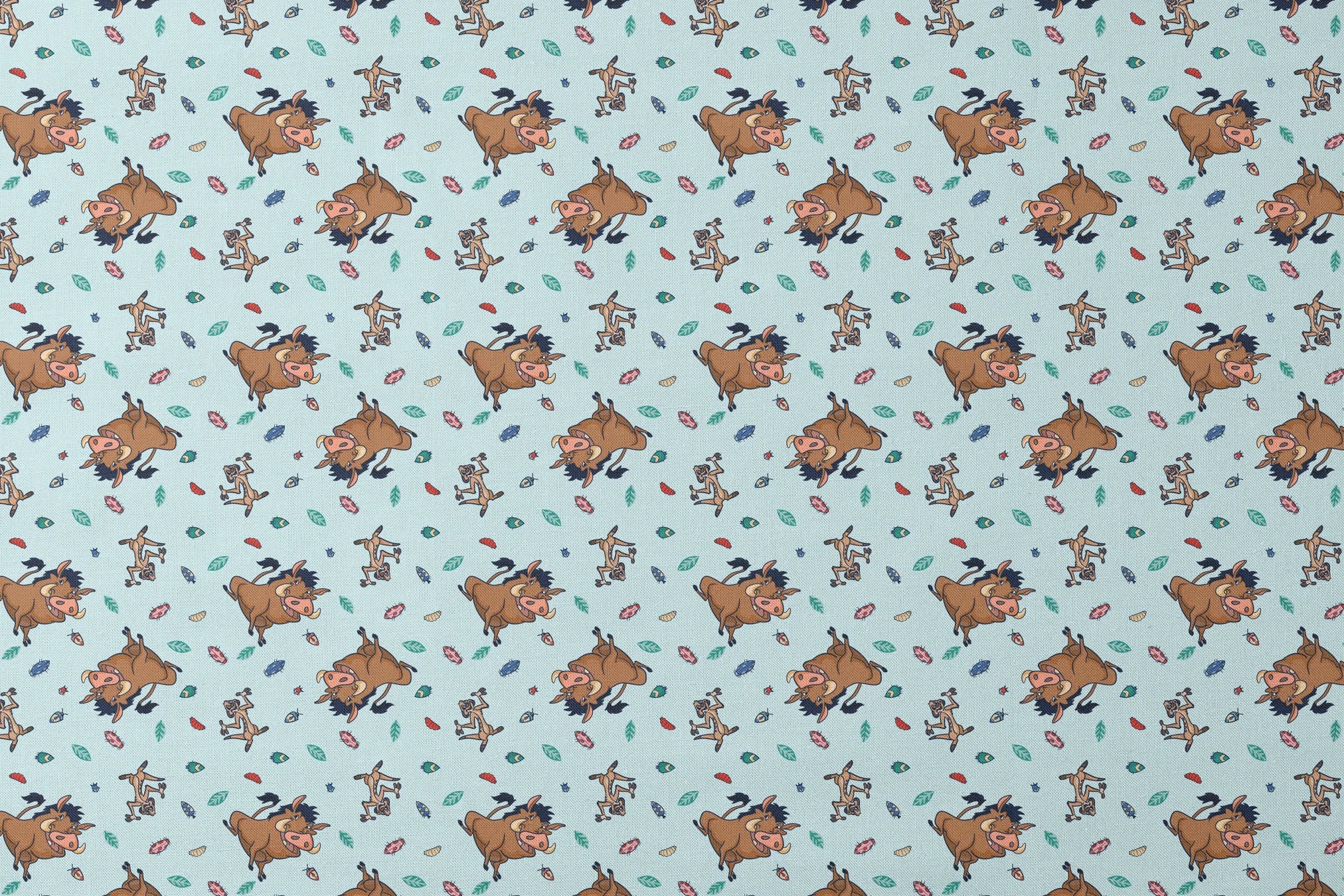 Lion King characters and colorful leaves scattered on light blue background in playful pattern designs flat mockup