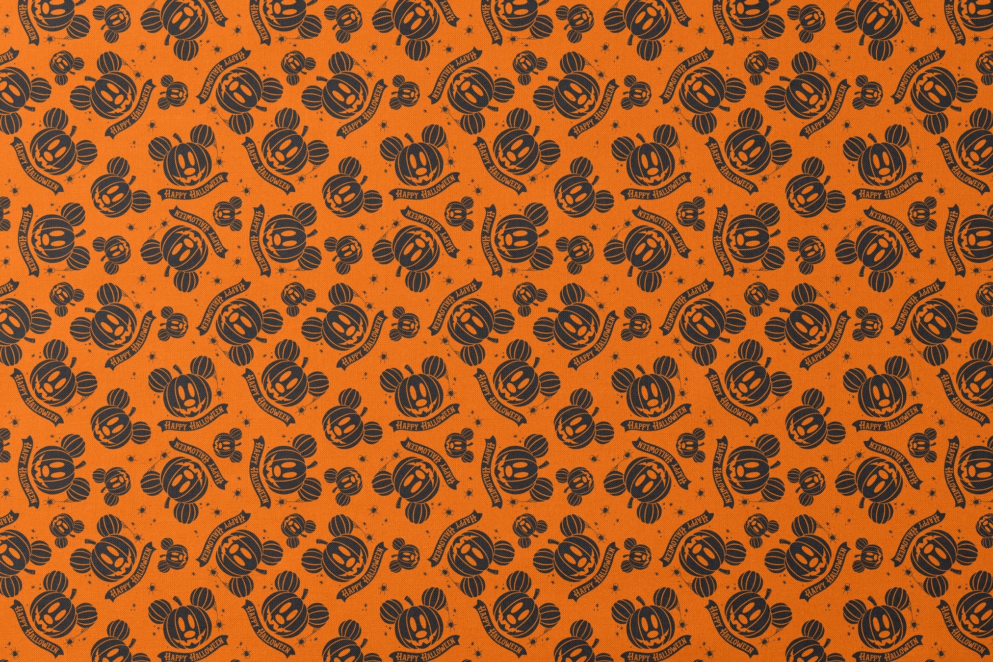 Halloween pattern with Disney-inspired jack-o'-lantern pumpkins and "Happy Halloween" text on bright orange background designs flat mockup