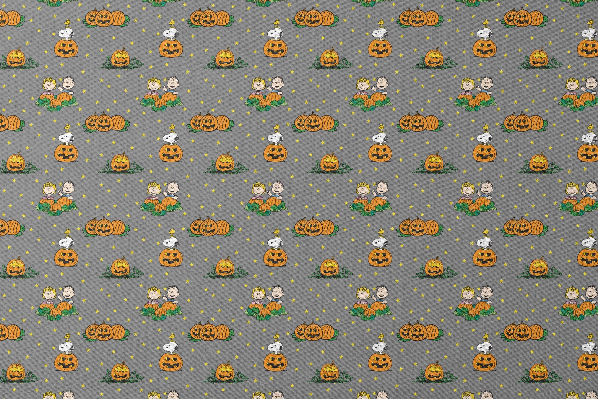 Peanuts Halloween pattern with Snoopy on pumpkins, Peanuts characters in pumpkin patches, and yellow stars on gray background. designs flat mockup