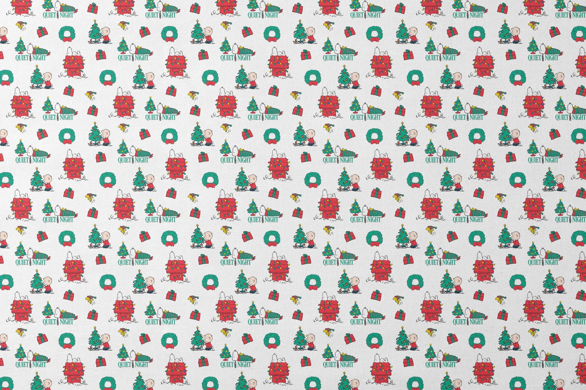Peanuts Christmas pattern with Snoopy's decorated doghouse, trees, wreaths, and "Quiet Night" text designs flat mockup