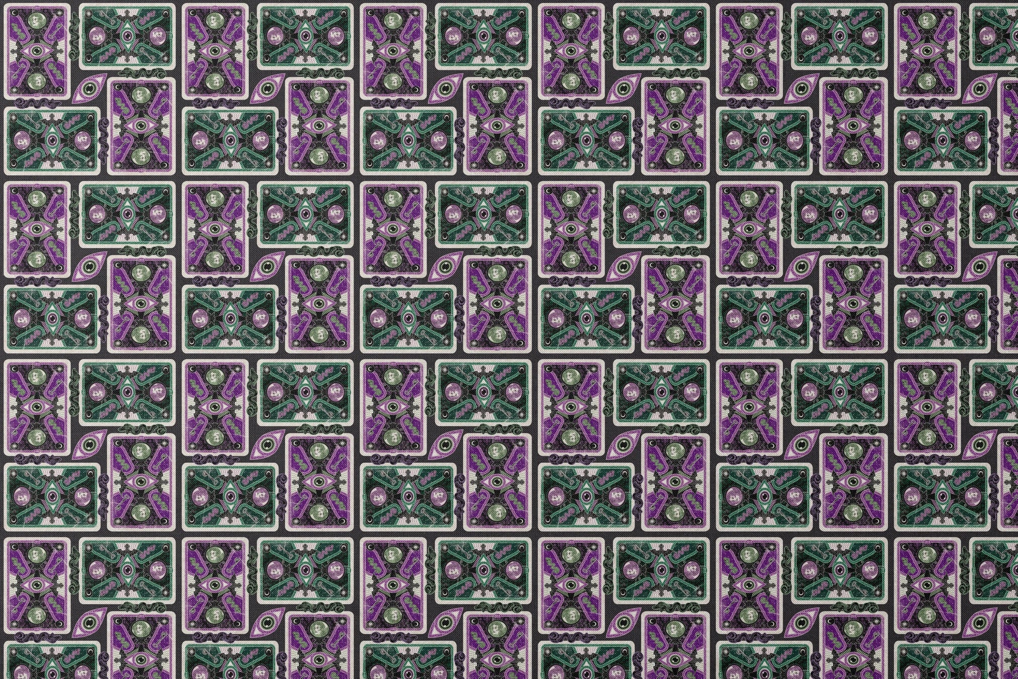Ornate playing card designs with purple and green patterns featuring central eye motifs and circular number elements against a black background. designs flat mockup