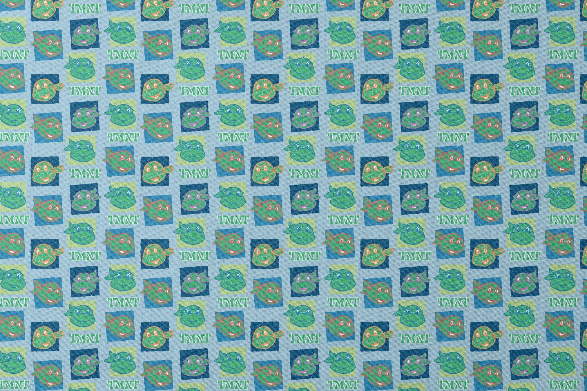 Teenage Mutant Ninja Turtles pattern with cartoon turtle faces in squares on light blue background designs flat mockup