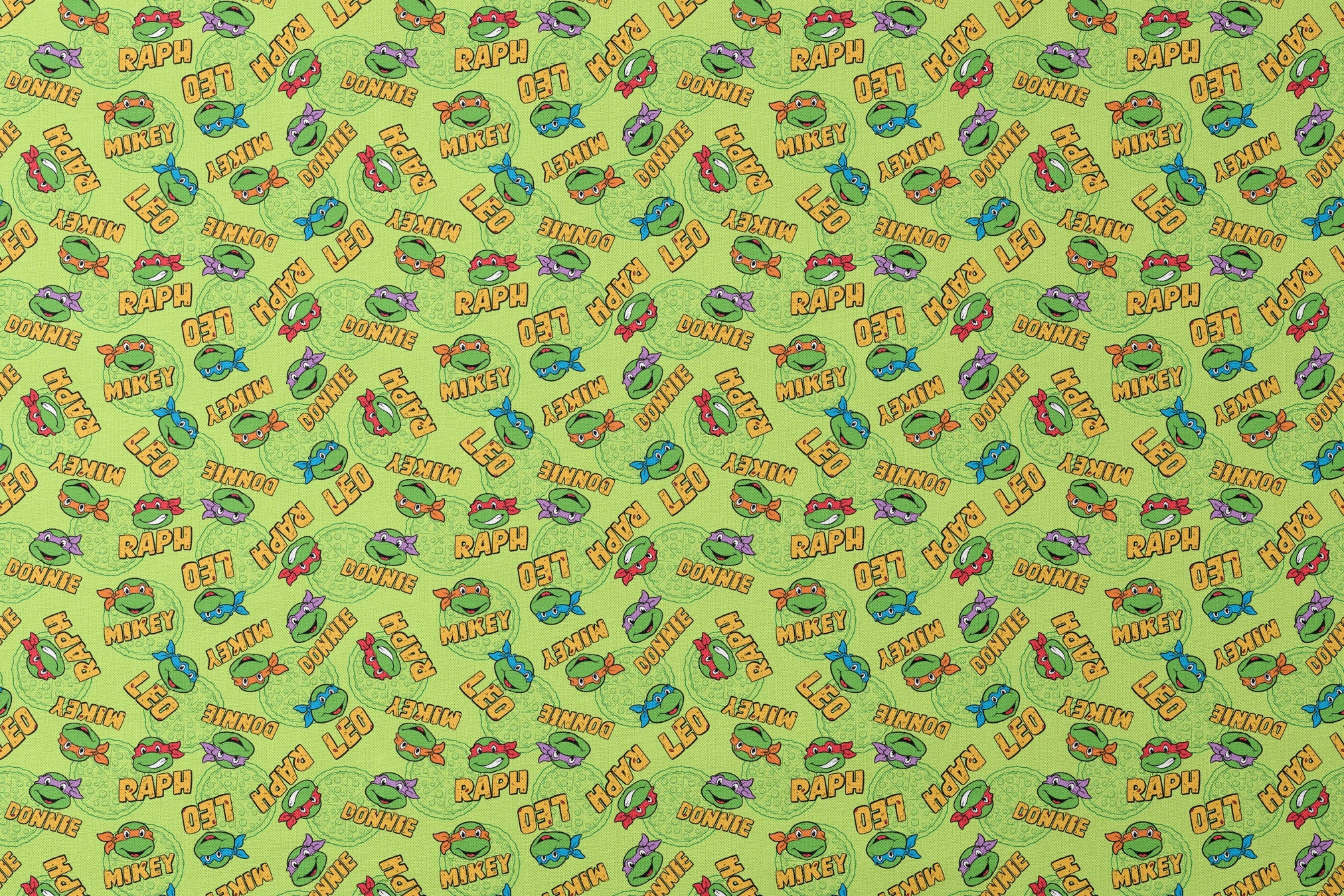 Teenage Mutant Ninja Turtles pattern with cartoon faces, names, and colorful masks on green background designs flat mockup