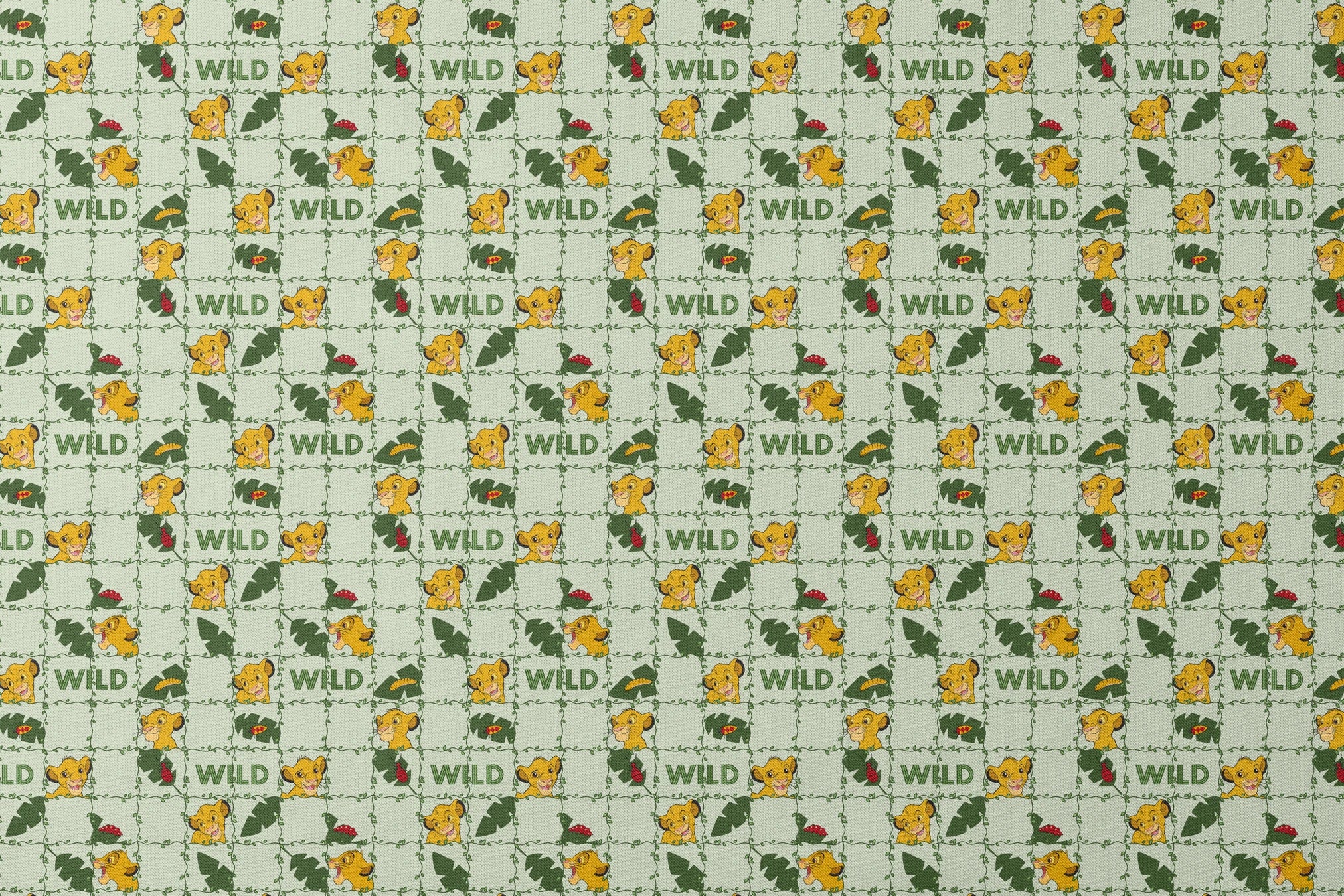 Young cartoon lion cubs with tropical leaves and "WILD" text on light green background pattern designs flat mockup