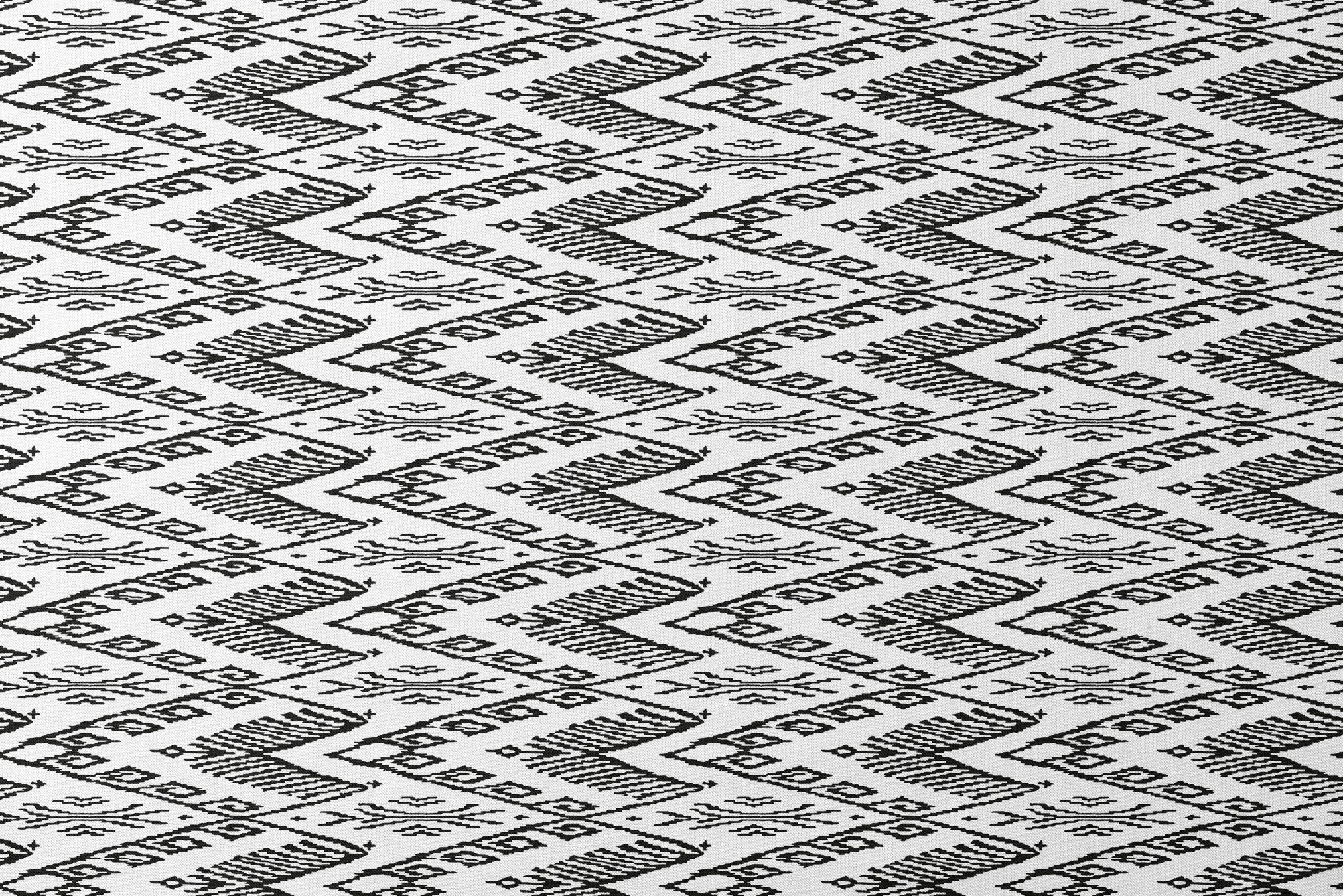 Black and white geometric pattern with diamond shapes and zigzag motifs on a textile surface designs flat mockup