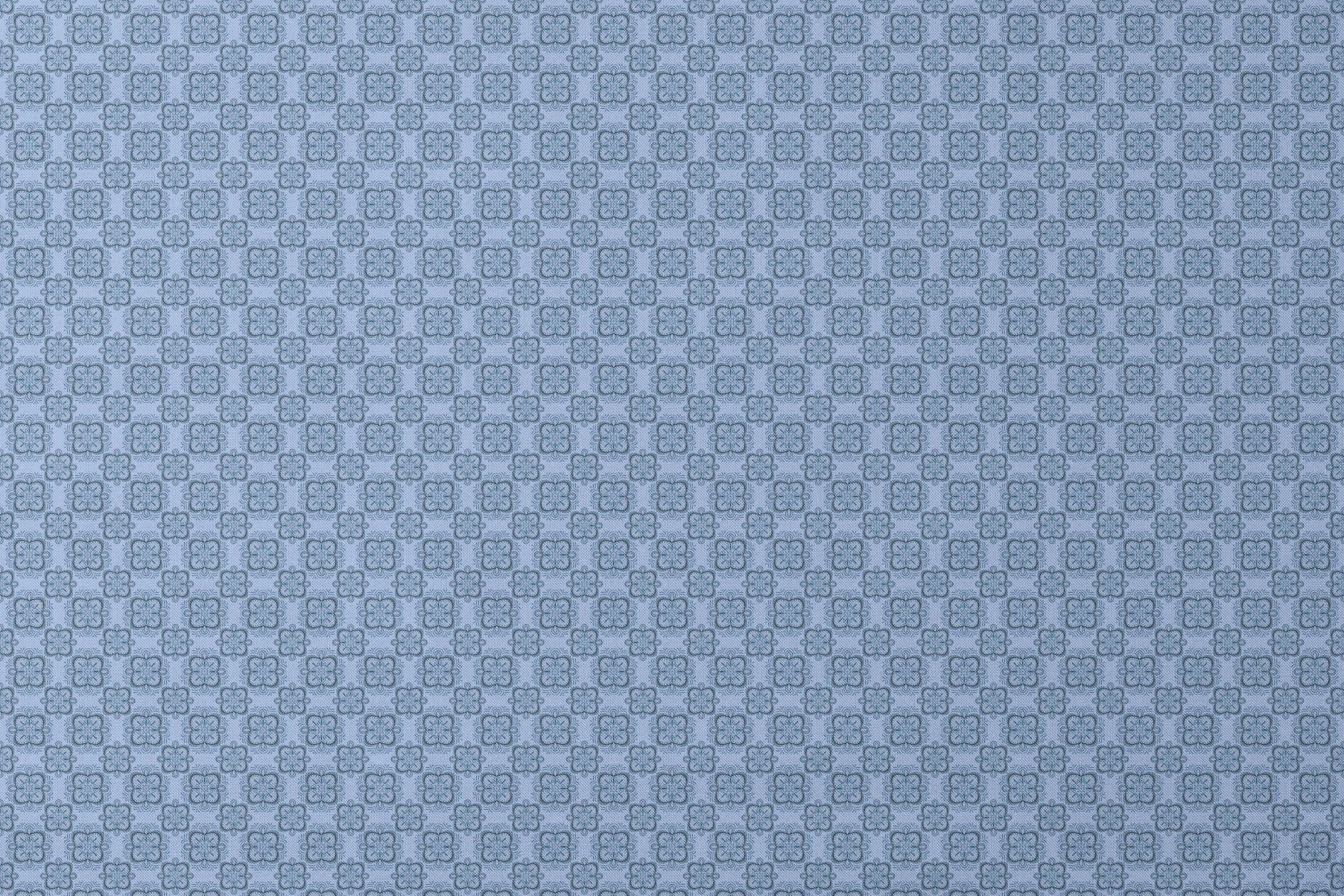 Symmetrical floral mandala pattern in layered blue tones with hand-drawn botanical details, designed by Nicole Tamarin. designs flat mockup