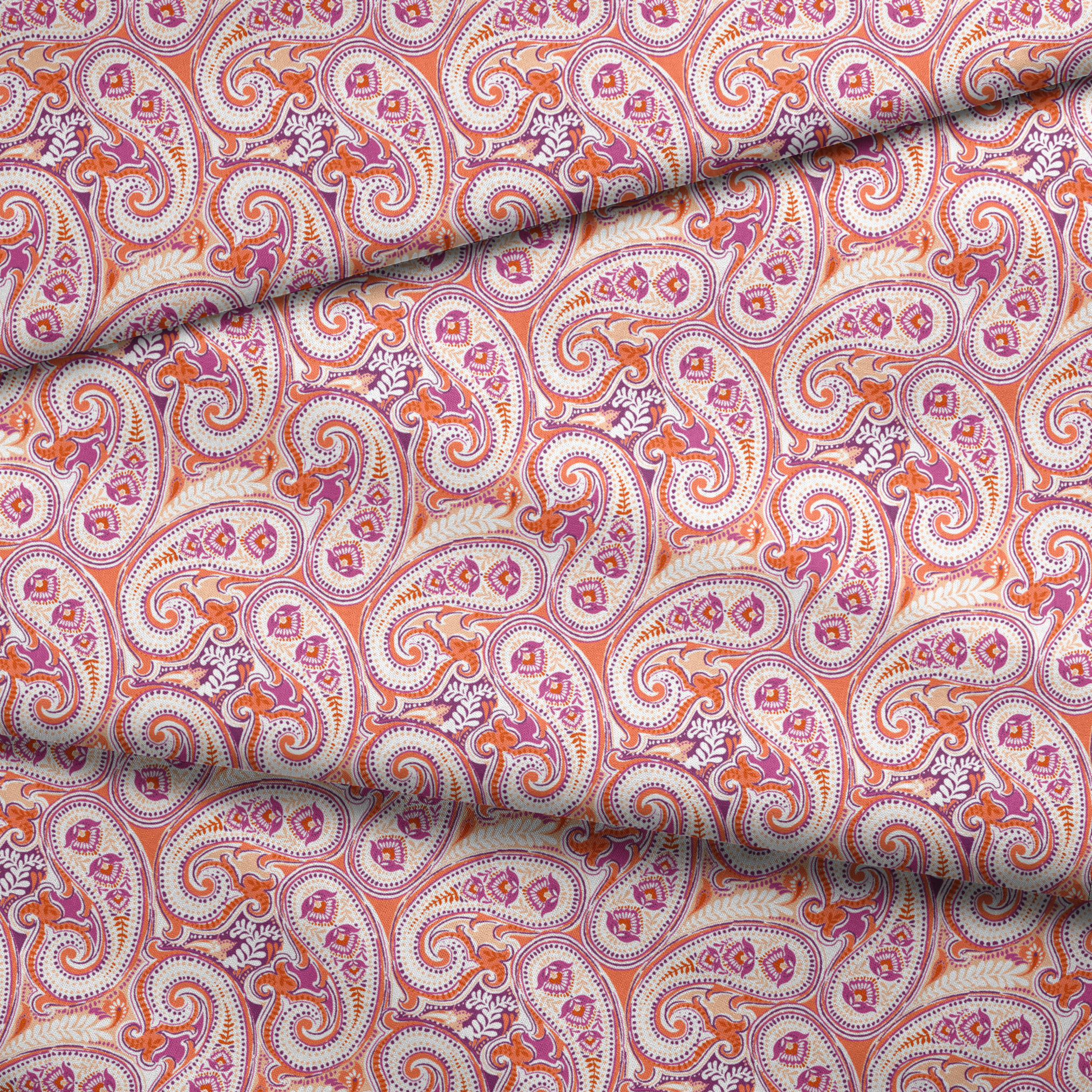 Vibrant paisley pattern in orange, pink and purple with swirling teardrop motifs and ornate details fabric fold mockup