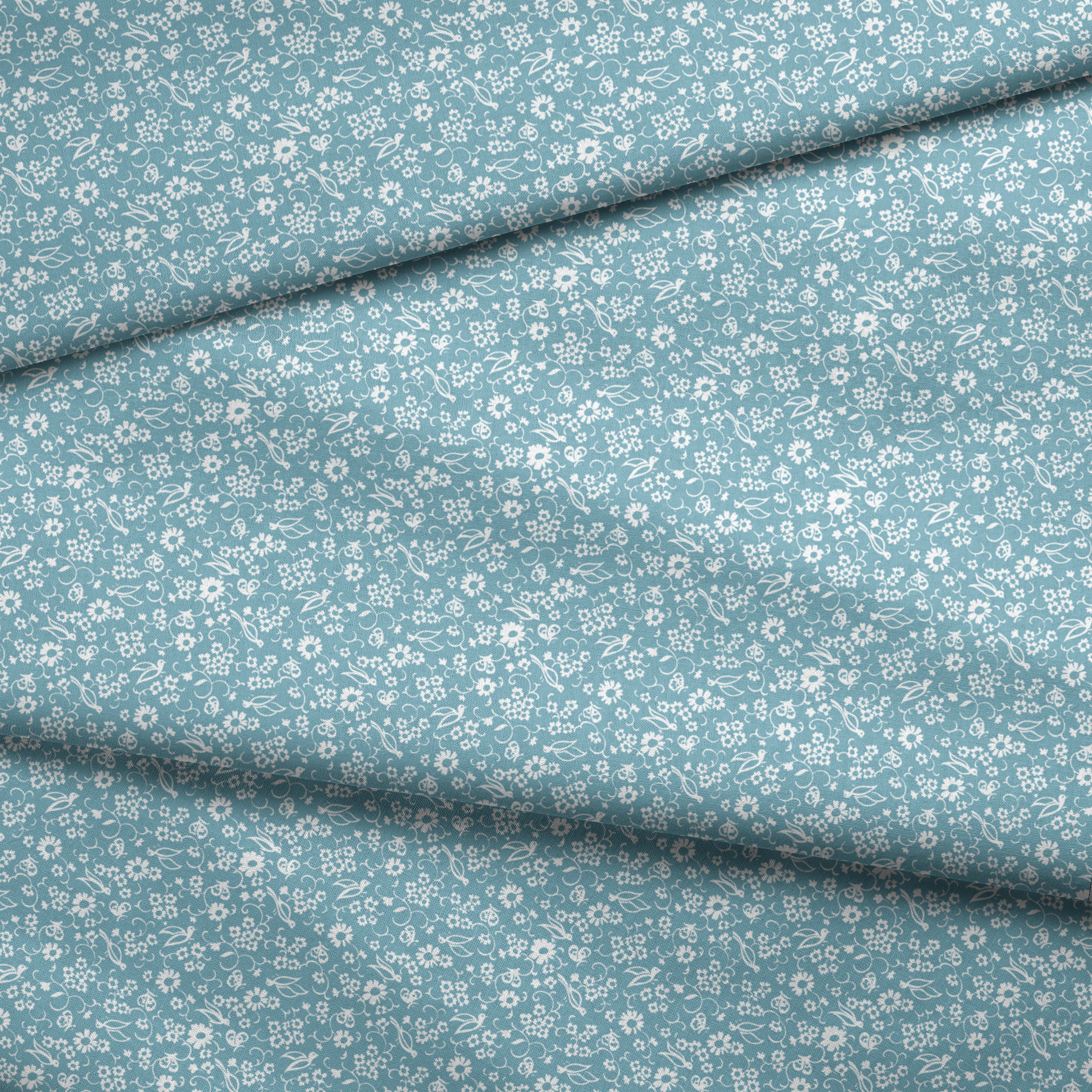 White vintage-style bird and floral silhouettes on a dusty blue background. fabric fold mockup