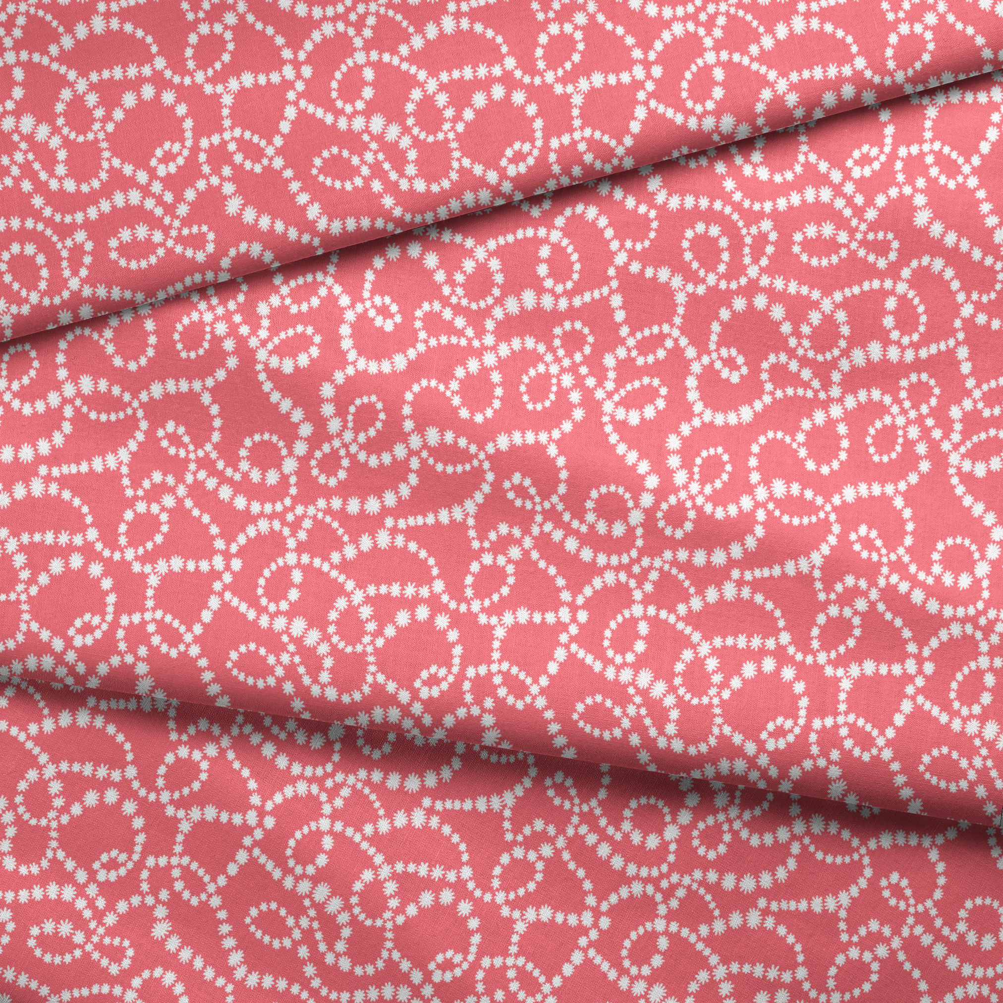 White dot patterns forming swirling chains on coral pink background fabric fold mockup