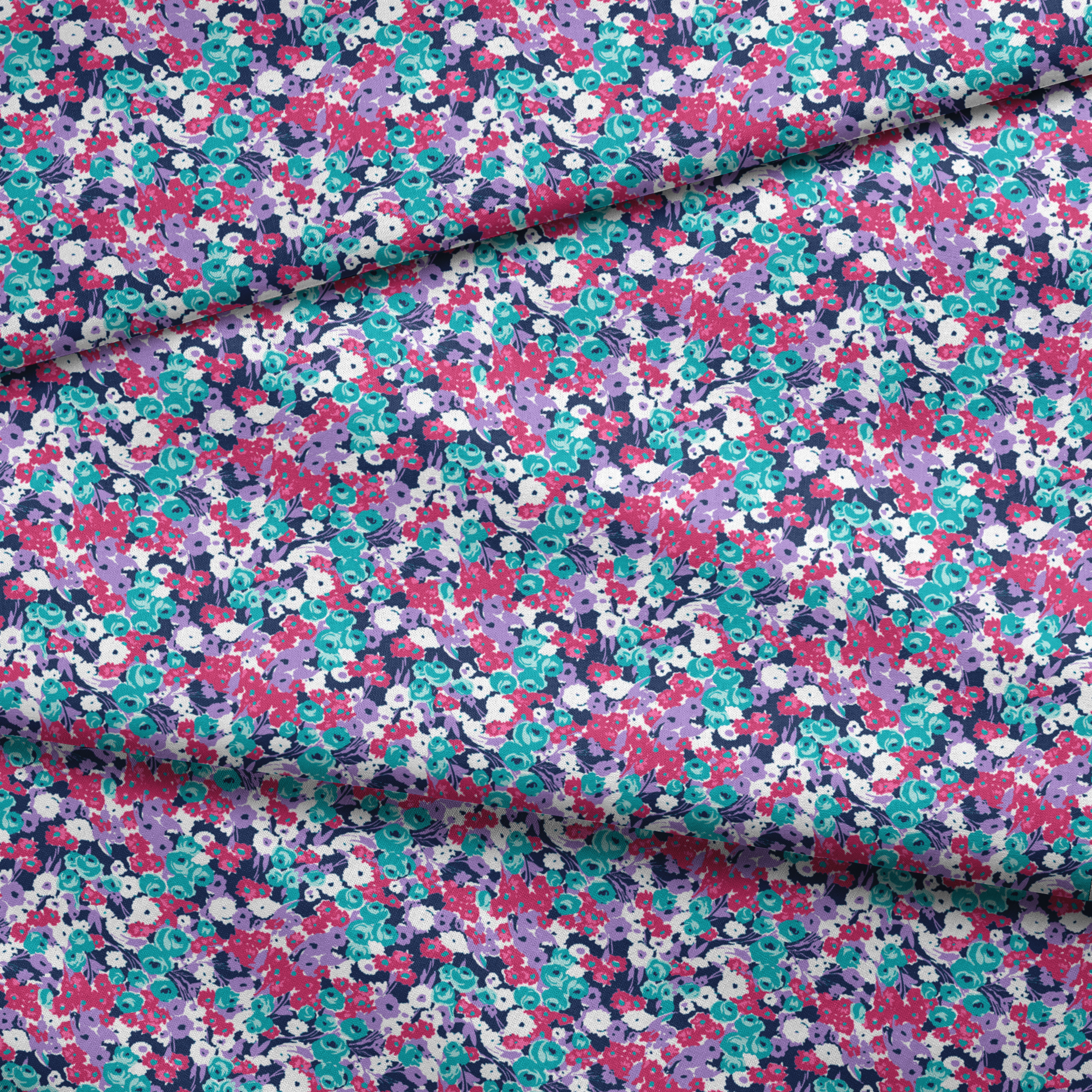 Vibrant floral pattern with pink, white, purple, and turquoise flowers on dark indigo background fabric fold mockup