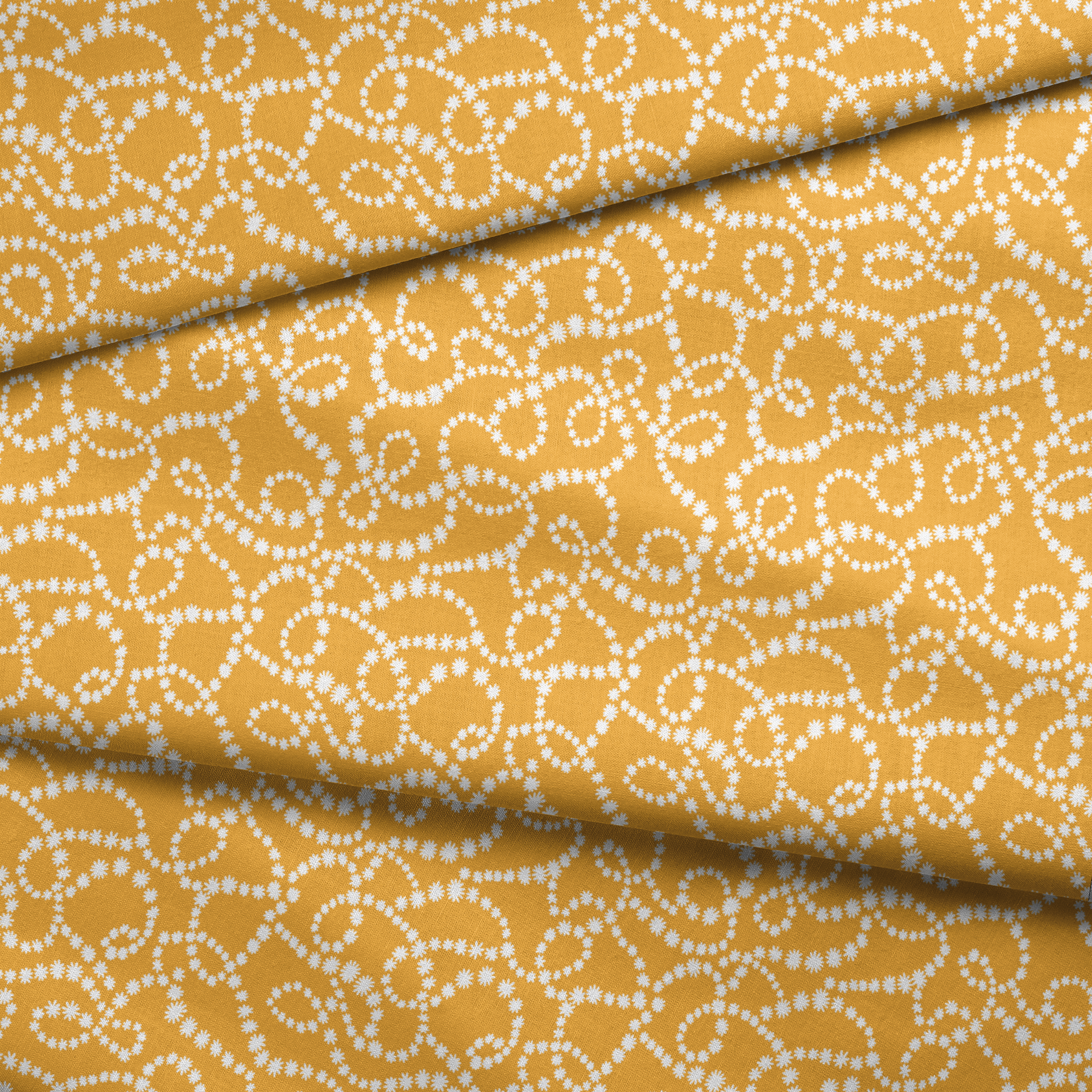 Mustard yellow background with swirling dotted white patterns forming organic circular designs fabric fold mockup
