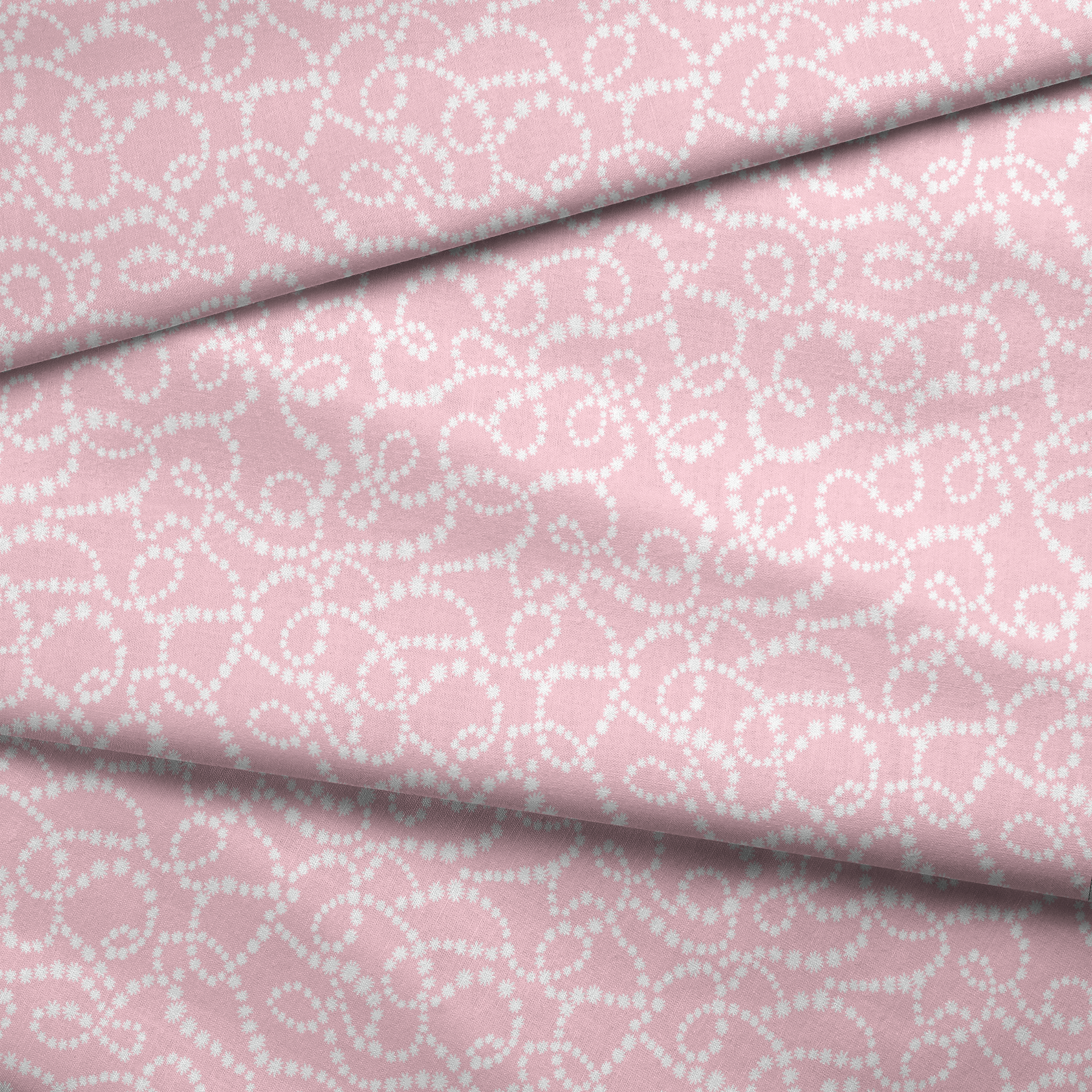 Baby pink background with white dotted swirling pattern creating delicate curved lines and loops fabric fold mockup