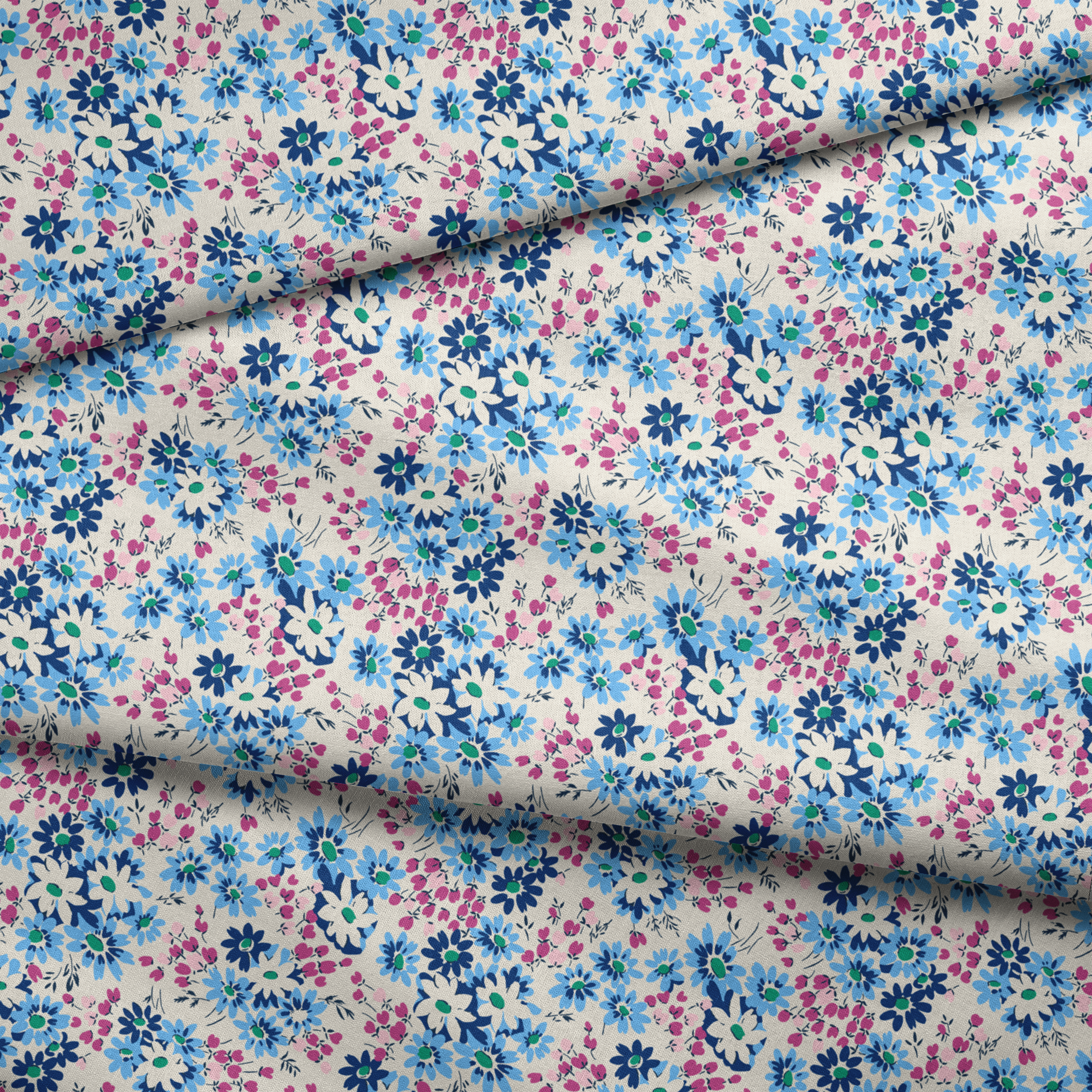 Floral pattern with blue, navy, and white daisies alongside small magenta berries on cream background fabric fold mockup