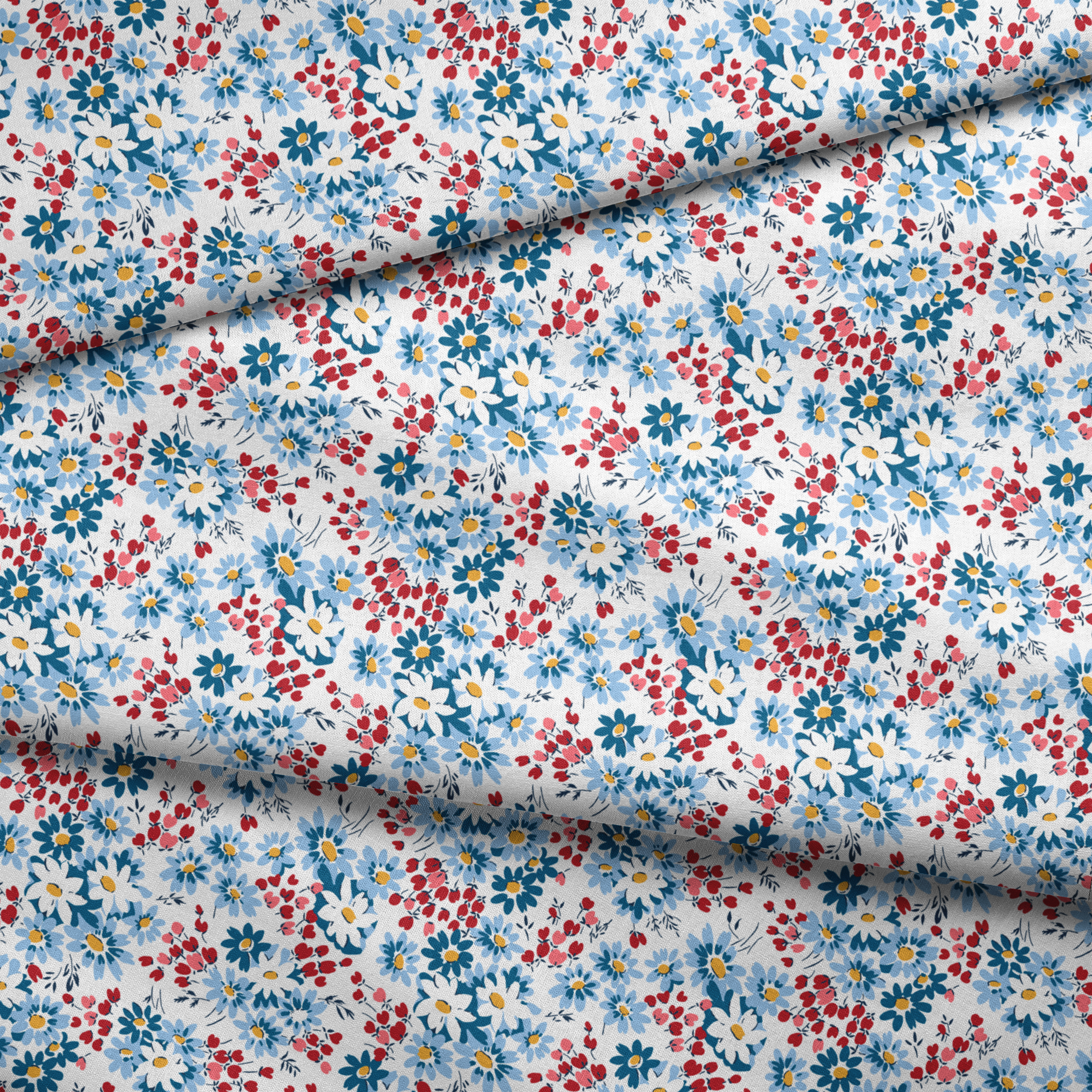 Blue and white daisies with small red berries scattered across a light background in a floral pattern fabric fold mockup