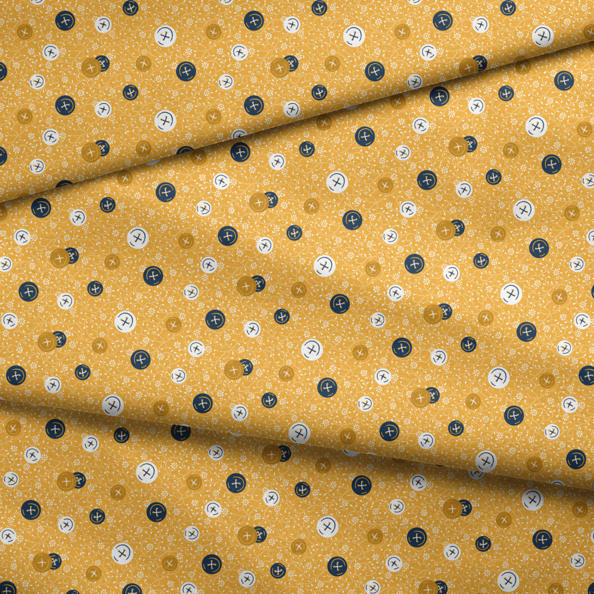 Circular buttons with cross symbols in gold, navy, and white scattered on a gold floral background fabric fold mockup
