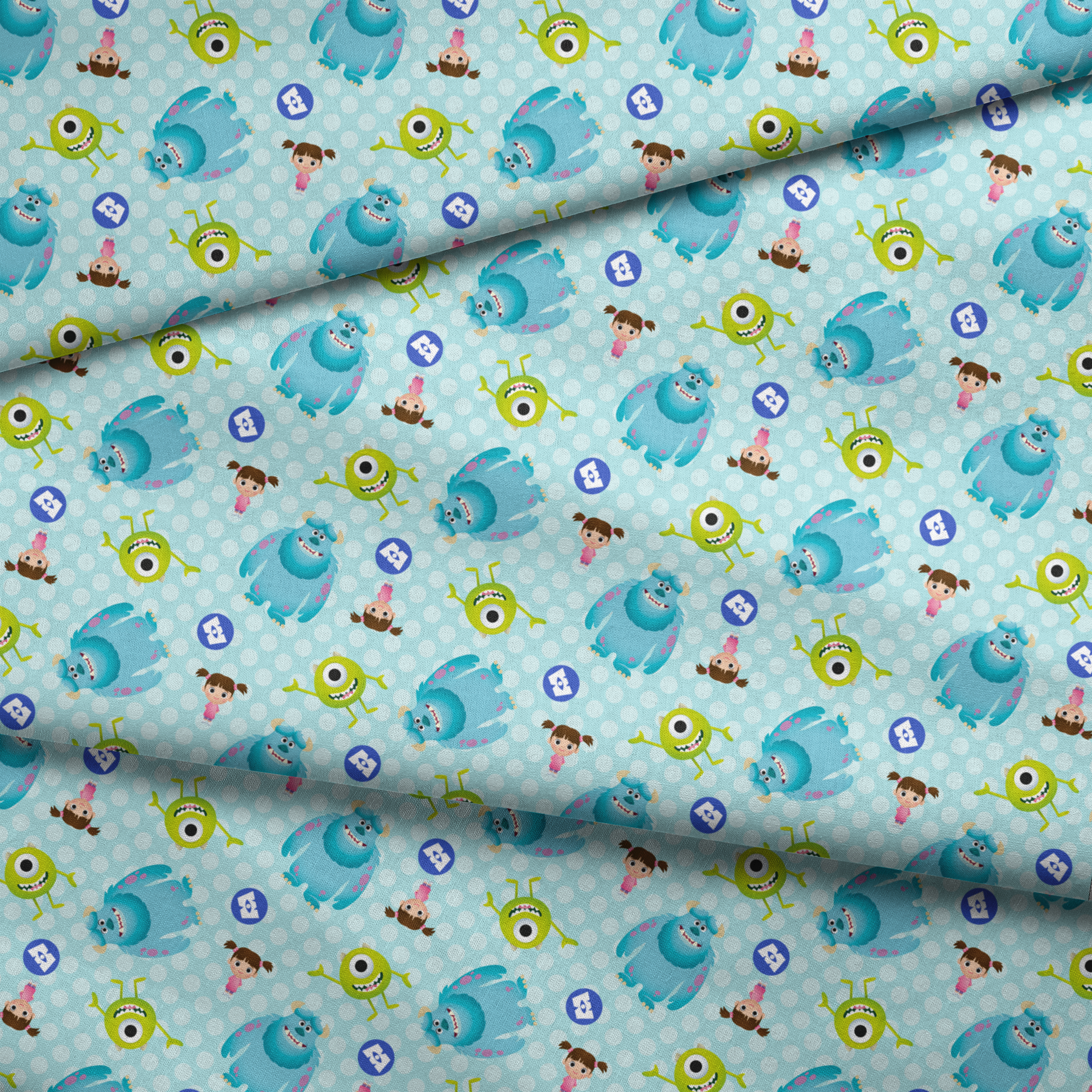 Cartoon Monsters Inc characters on light blue polka dot background fabric fold mockup