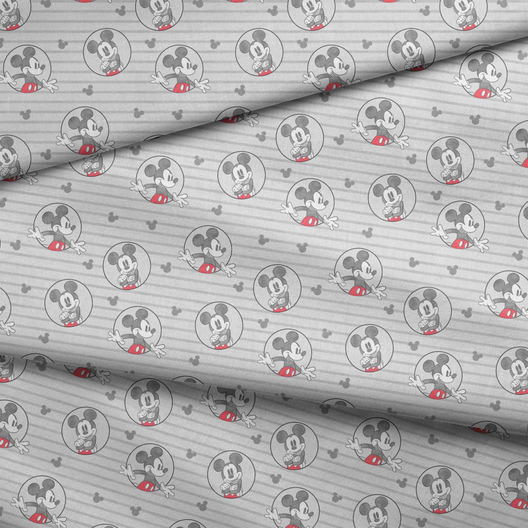 Mickey Mouse pattern on gray striped background with circular character portraits in red, black, and white fabric fold mockup