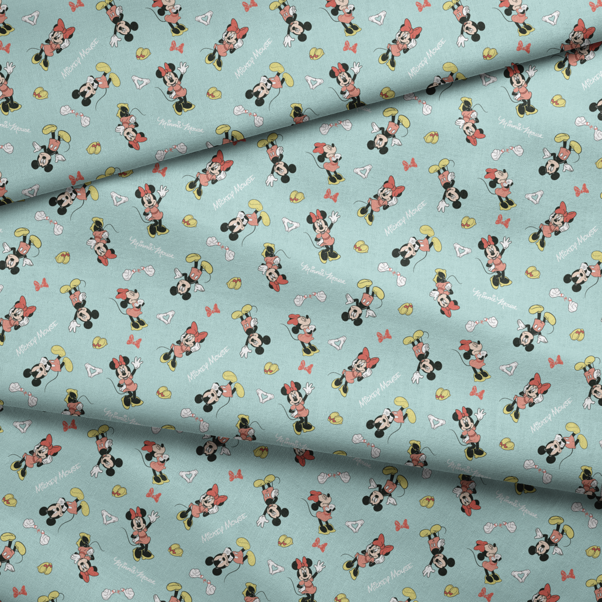 Mickey and Minnie Mouse pattern on light turquoise background with scattered characters, bows, and gloves fabric fold mockup