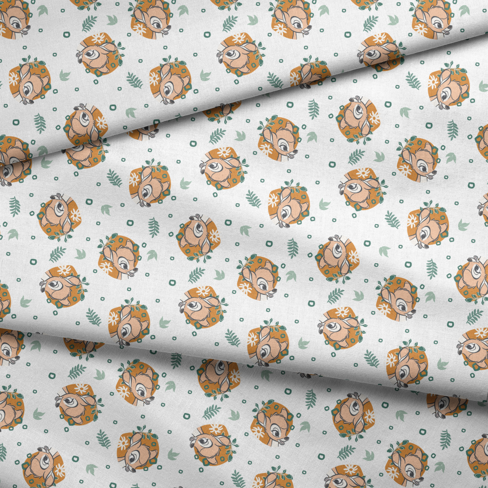 Disney’s Bambi illustrated in golden-orange floral medallions with green leaves and scattered geometric accents on a white background. fabric fold mockup