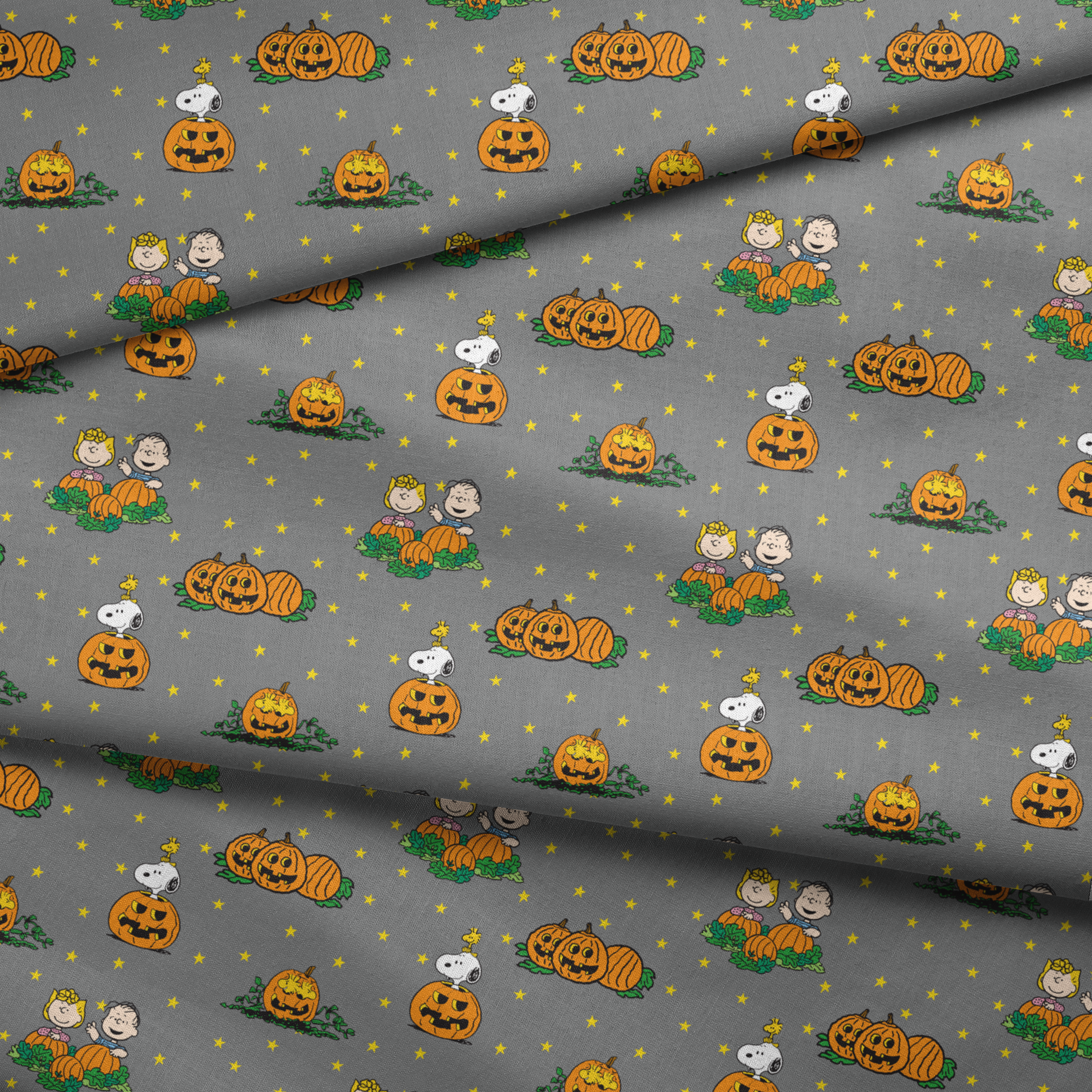 Peanuts Halloween pattern with Snoopy on pumpkins, Peanuts characters in pumpkin patches, and yellow stars on gray background. fabric fold mockup